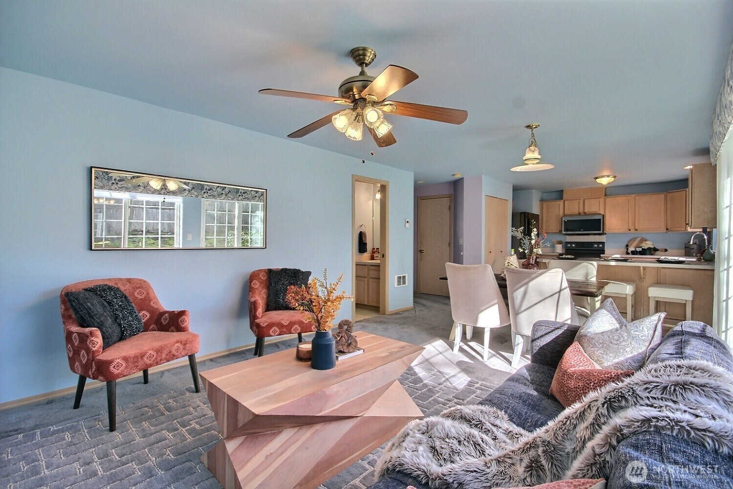 Enjoy effortless flow from the cozy family room to the adjacent dining area and well-appointed kitchen.  The half bath can be seen in the photo on the left.