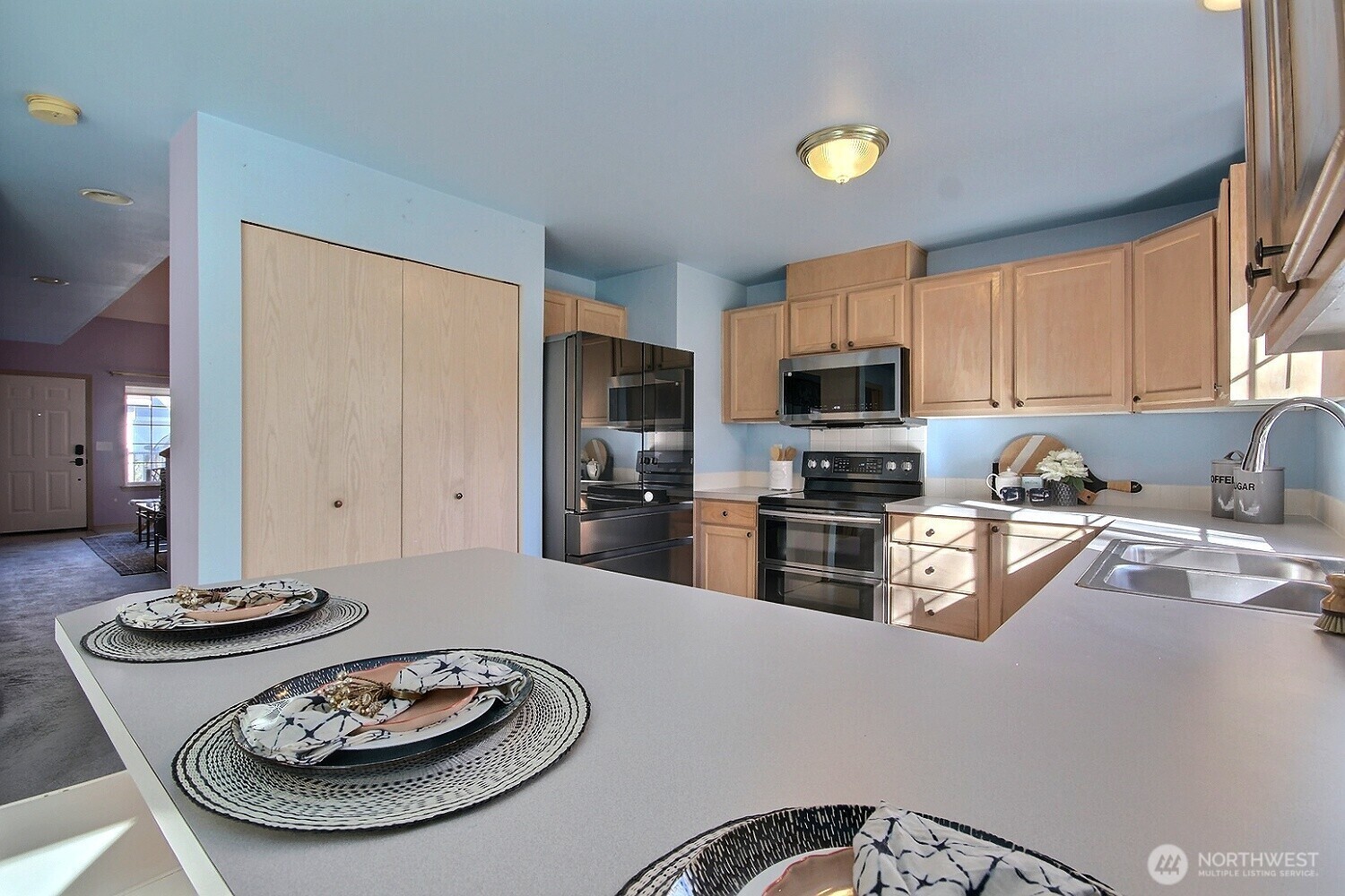 The kitchen features a Smart refridgerator, newer micro, electric stove/oven, dishwasher - all included, plus a double sink with garbage disposal.