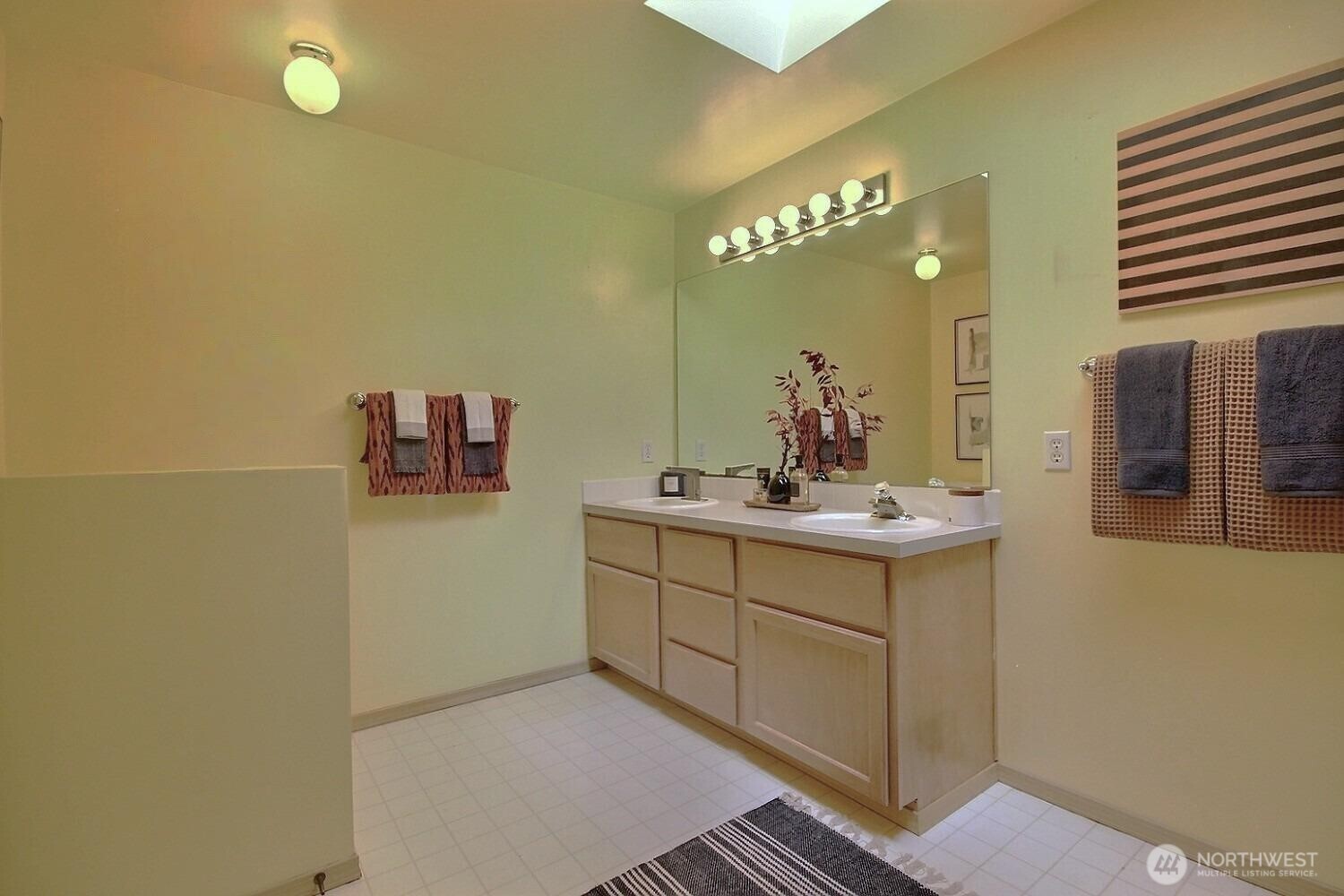 Enjoy the large vanity that offers an aboundance of counter space and dual sinks, providing a seamless morning routine with plenty of room for two.  There's even extra space for a storage piece of dresser, bureau.