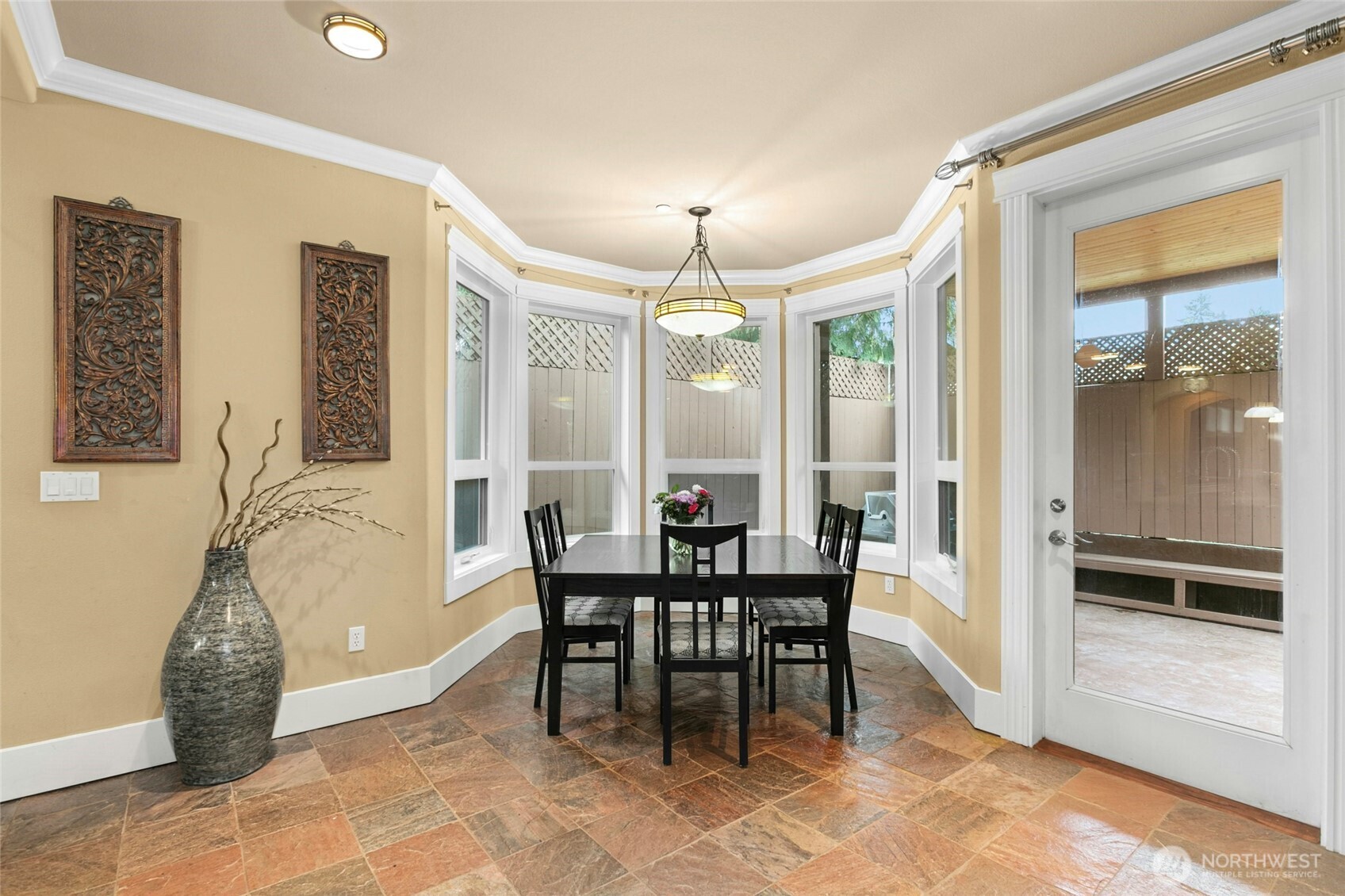 Breakfast nook seamlessly connected to the backyard patio with a built-in gas grill—ideal for indoor-outdoor entertaining.