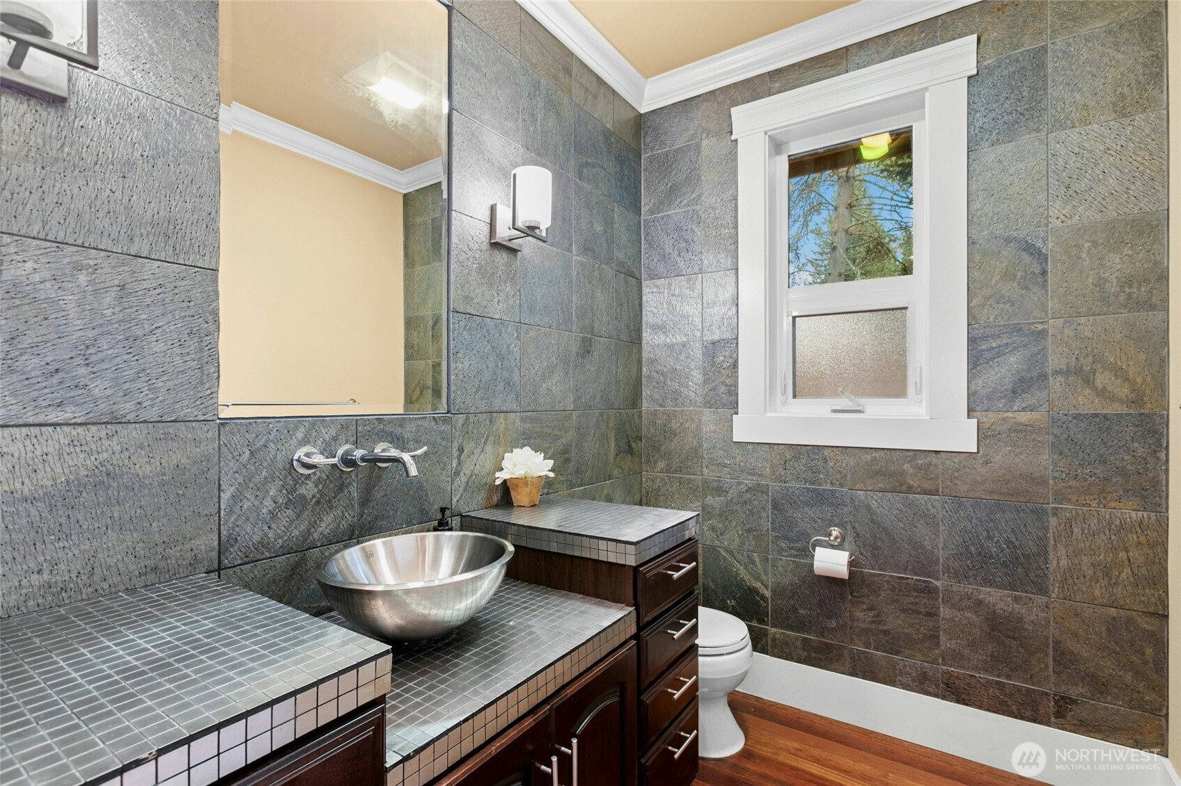 Beautifully appointed main-level powder room featuring refined craftsmanship and intricate detailing.