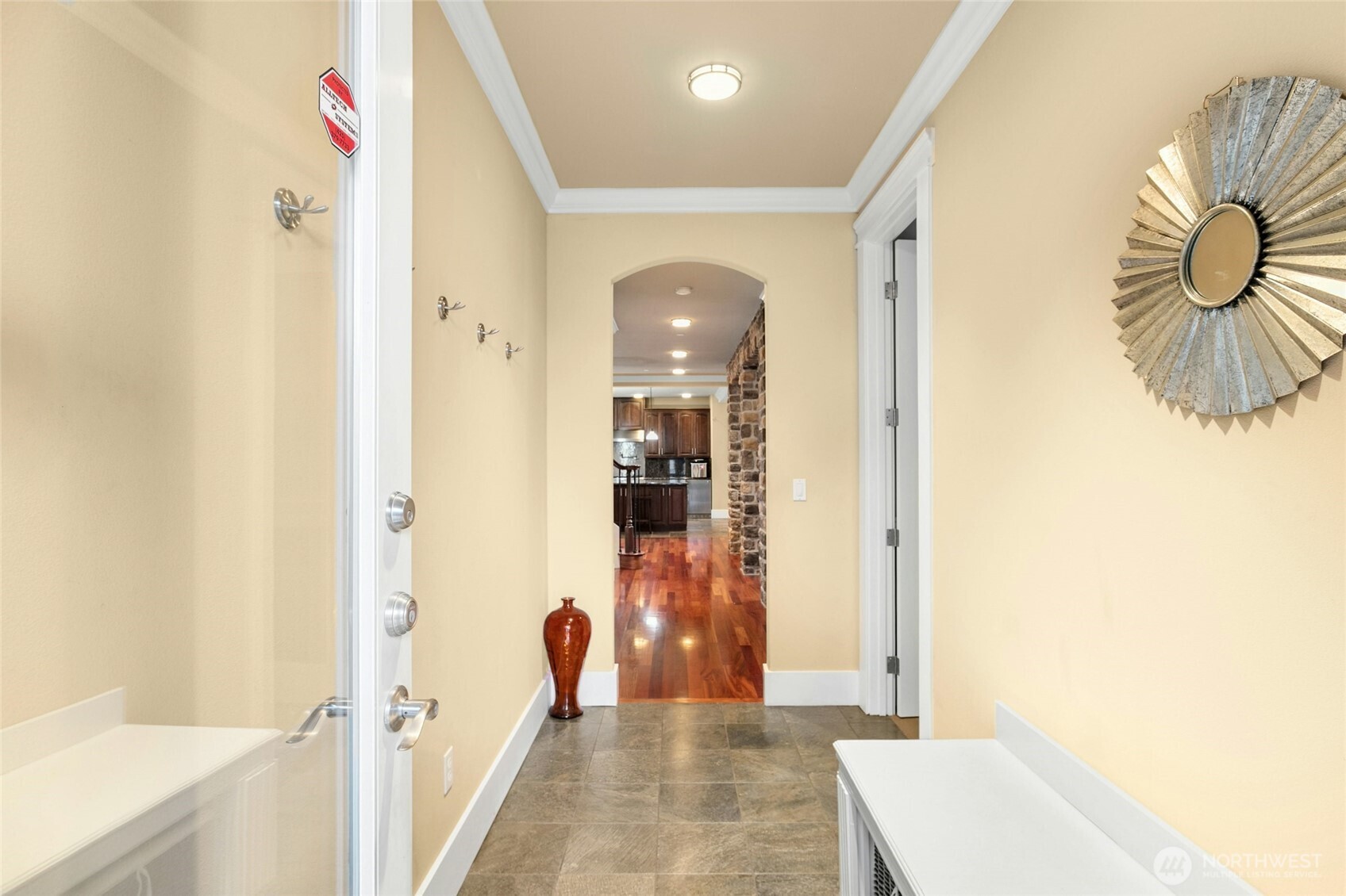 From the mudroom view, the den is on the right and the door on the left leads to the three-car garage.