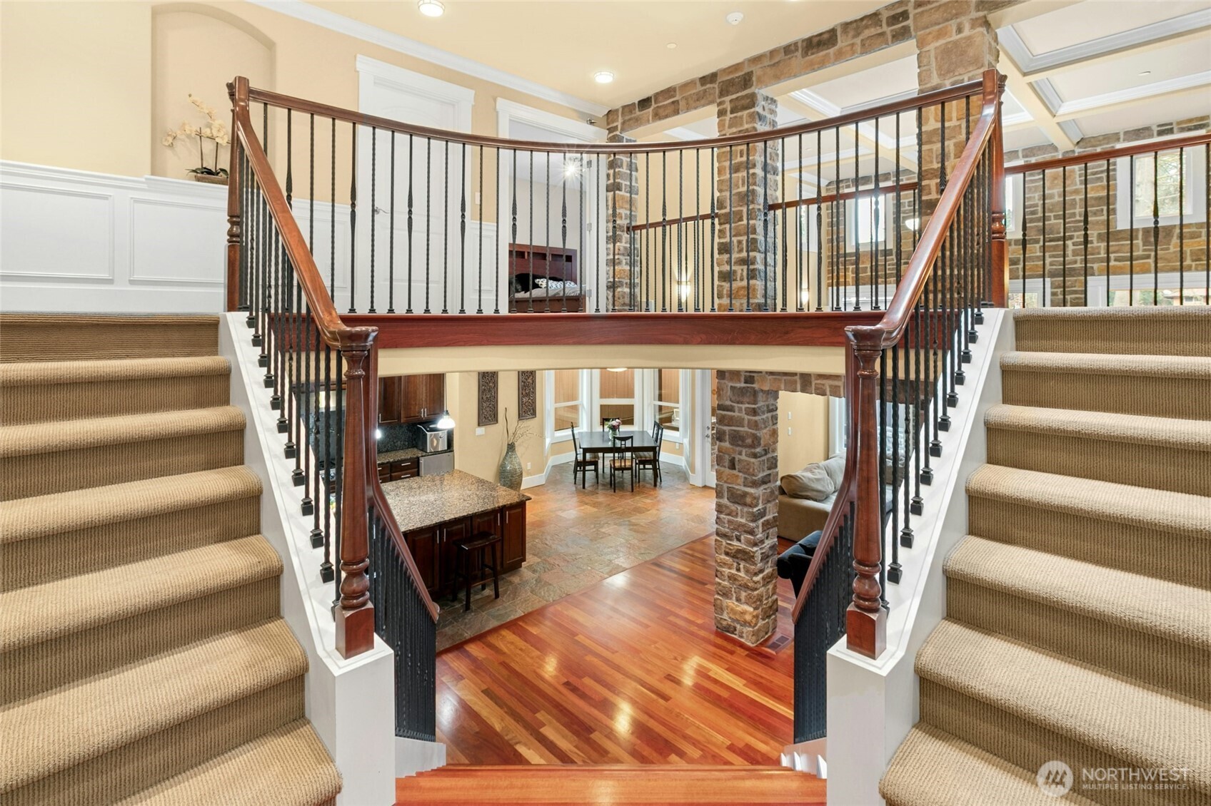 Elegant dual staircases to the main floor, highlighting the home’s striking architectural presence and solid craftsmanship.