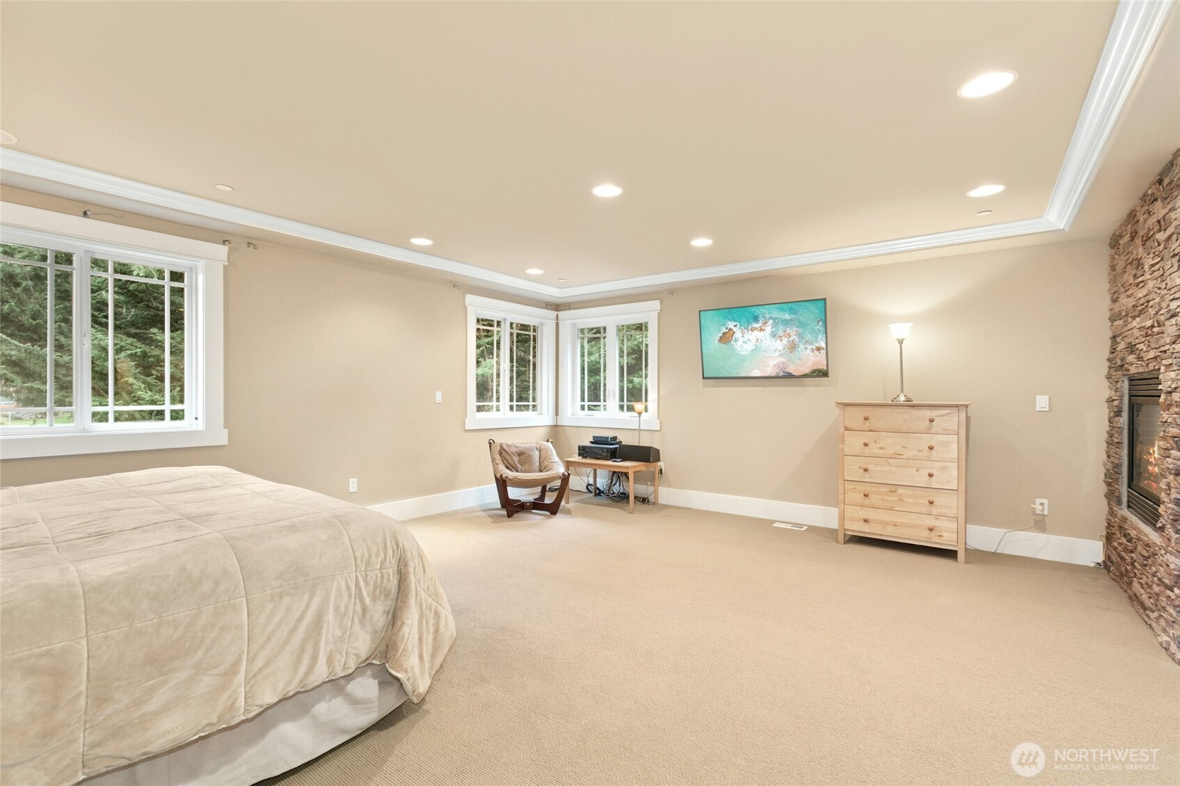 Luxurious primary suite highlighted by an elegant fireplace.