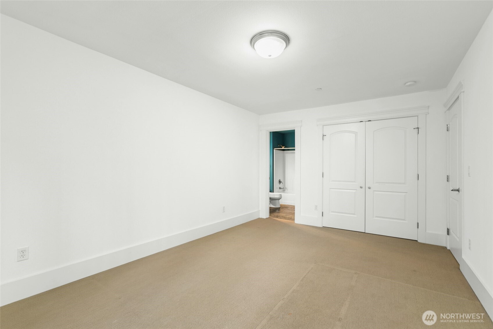 Spacious secondary bedroom with a large walk-in closet.