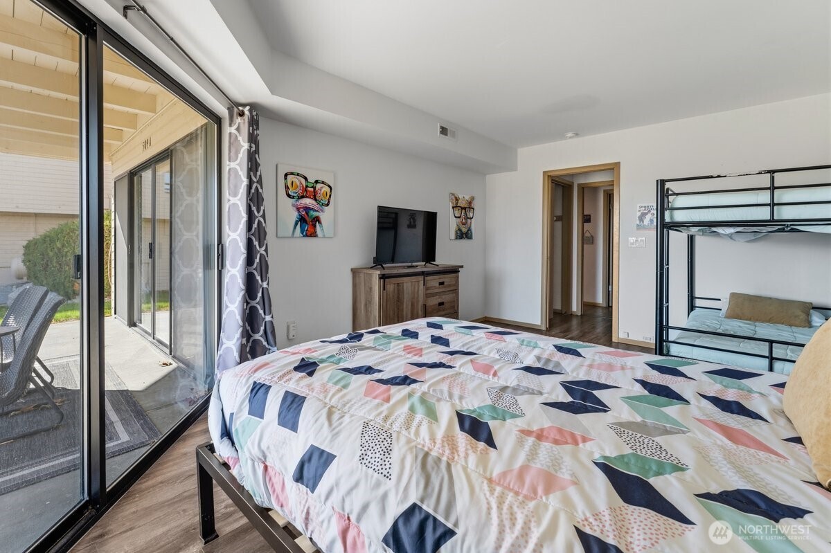 Lower Level Bedroom w/access to patio & lawn