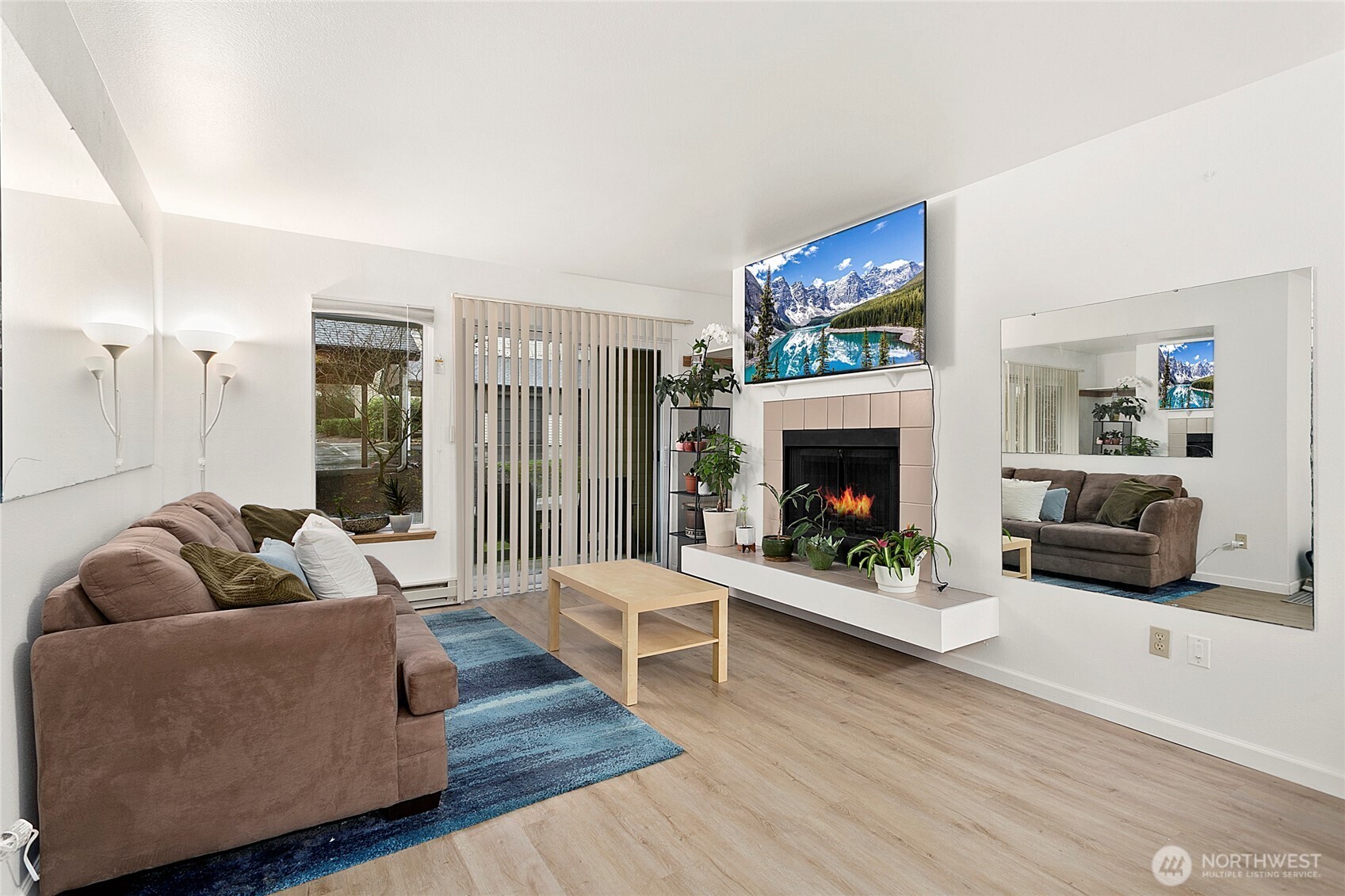 Spacious living room with nice updated flooring and a perch for your art, your plants, or your cat to enjoy.