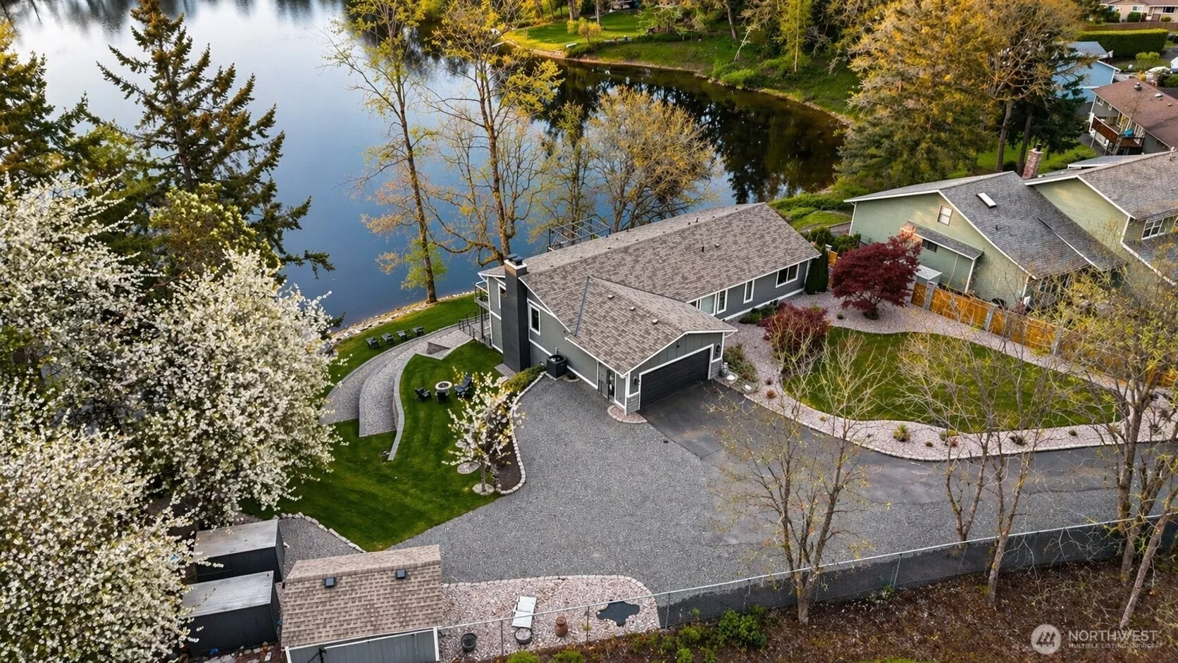 Rare no-bank waterfront with private dock, terraced entertaining spaces and seamless access to Carp Lake.