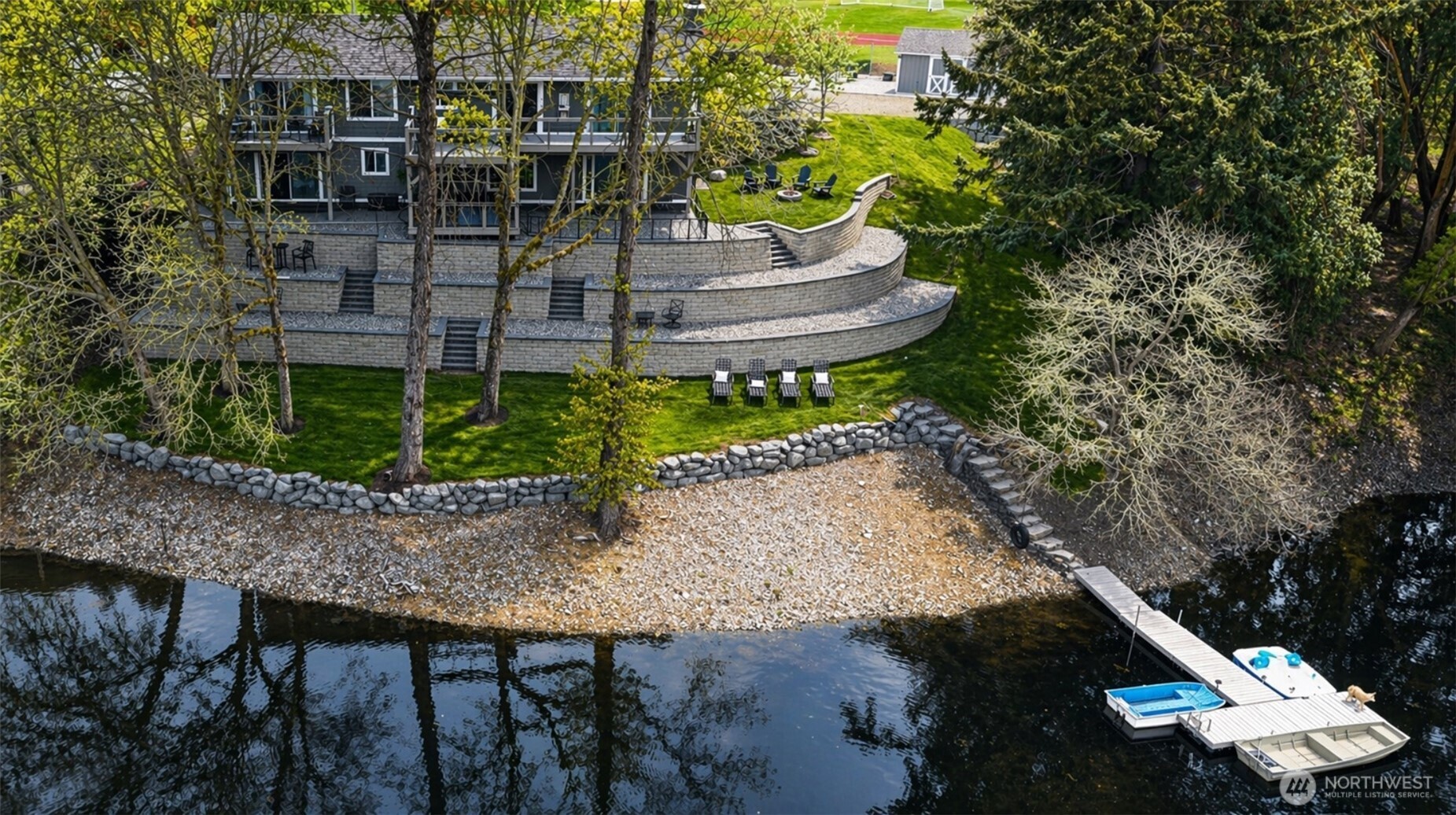 Thoughtfully designed outdoor spaces cascade to the water's edge, creating a true lakeside retreat.