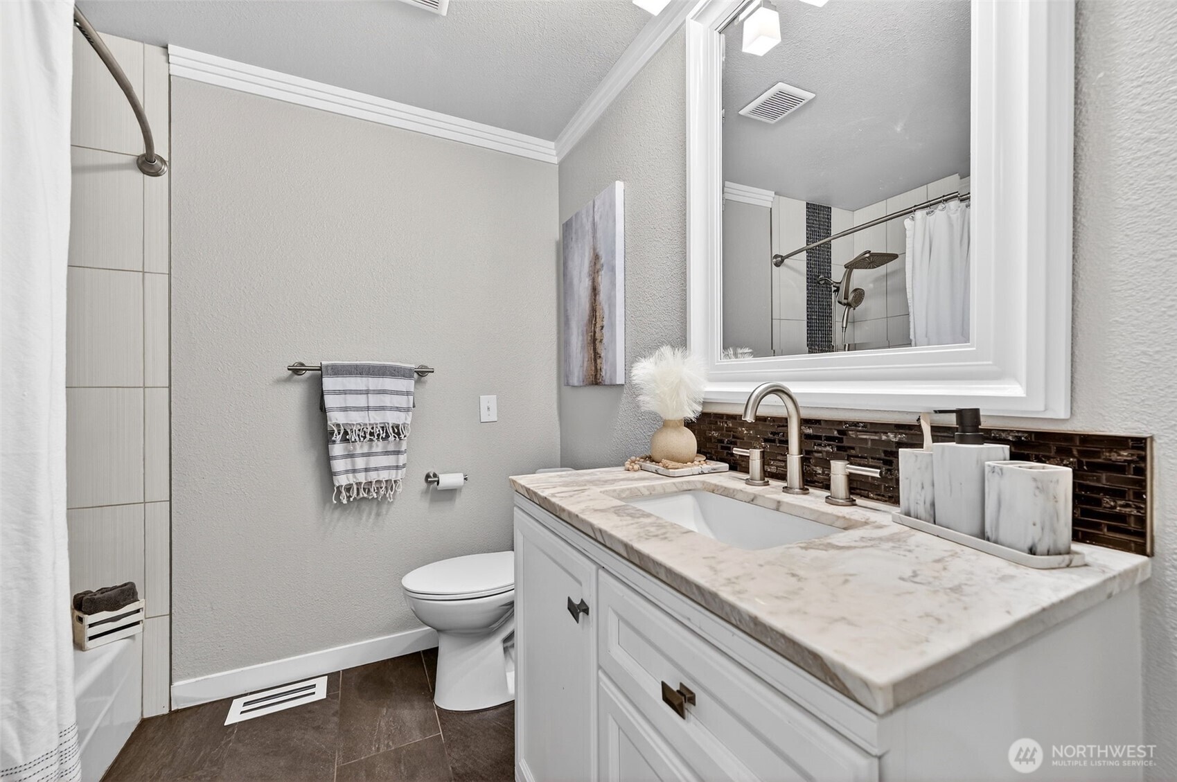 Bright bedroom with crown molding, plush carpet, and a walk-in closet.