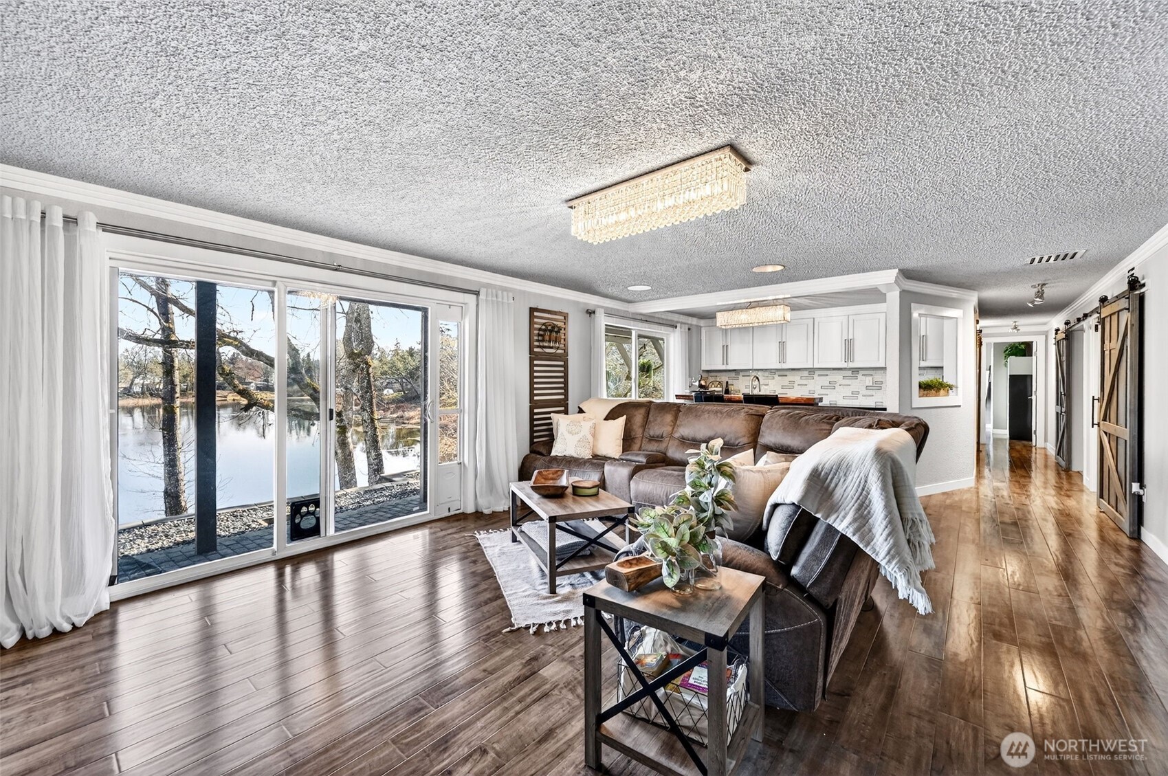 Open-concept lower family room with sweeping lake views.
