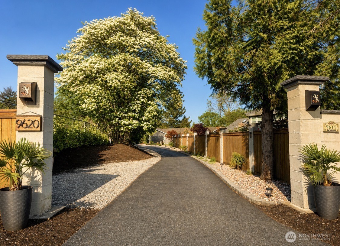 Arrive in style-Private, gated entry welcomes you into 1.1 acres of serene waterfront living on Carp Lake.
