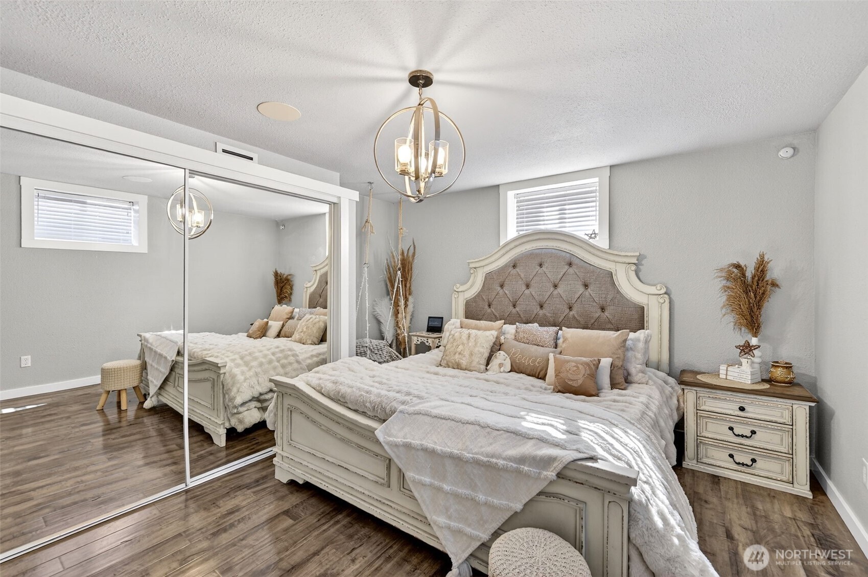 Rustic sliding barn doors and warm wood floors create a standout hallway with modern lighting.