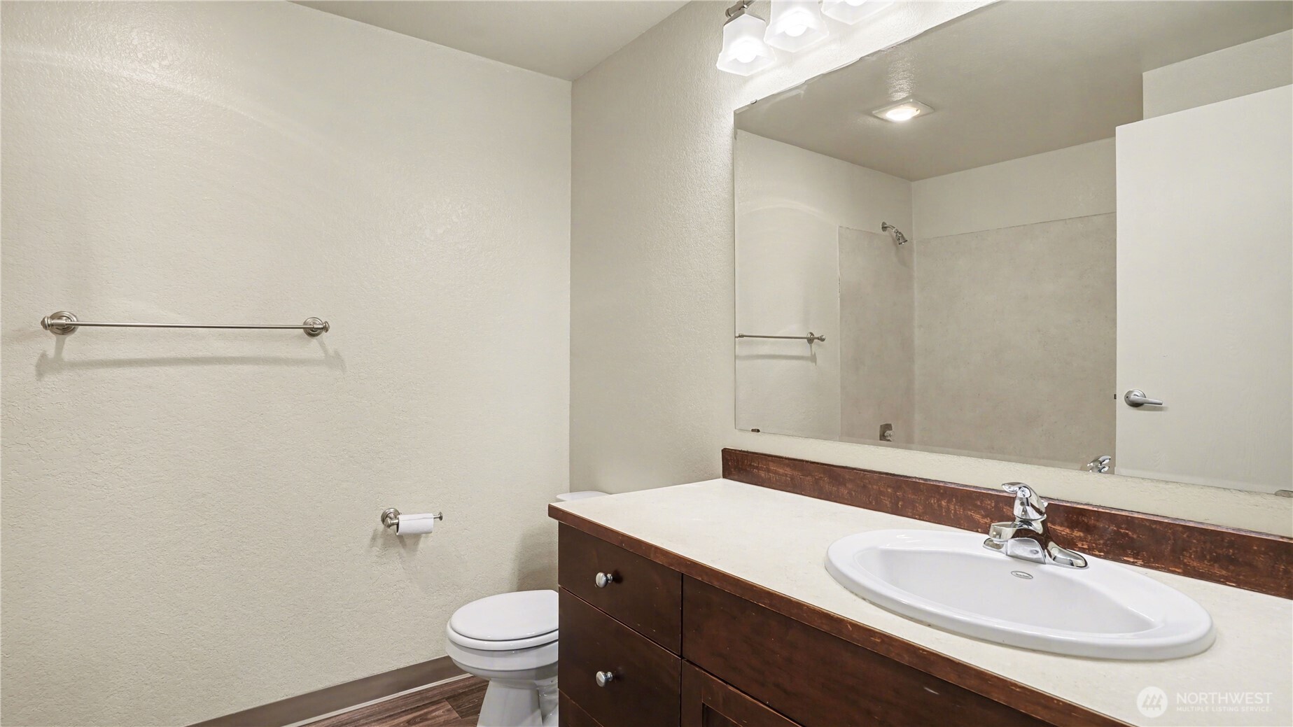 Primary bathroom with updated vanity offers an abundance of storage.