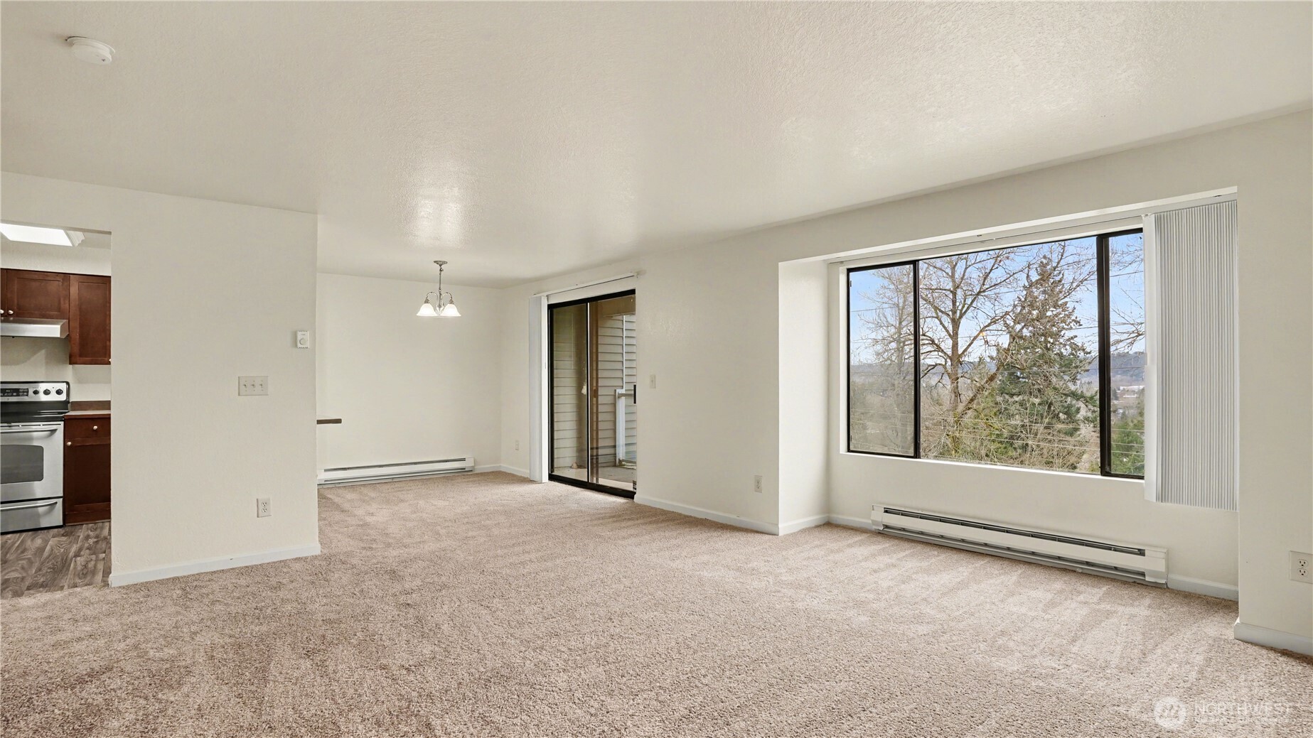 The living room offers the perfect ambiance with the natural light and the cozy fireplace.