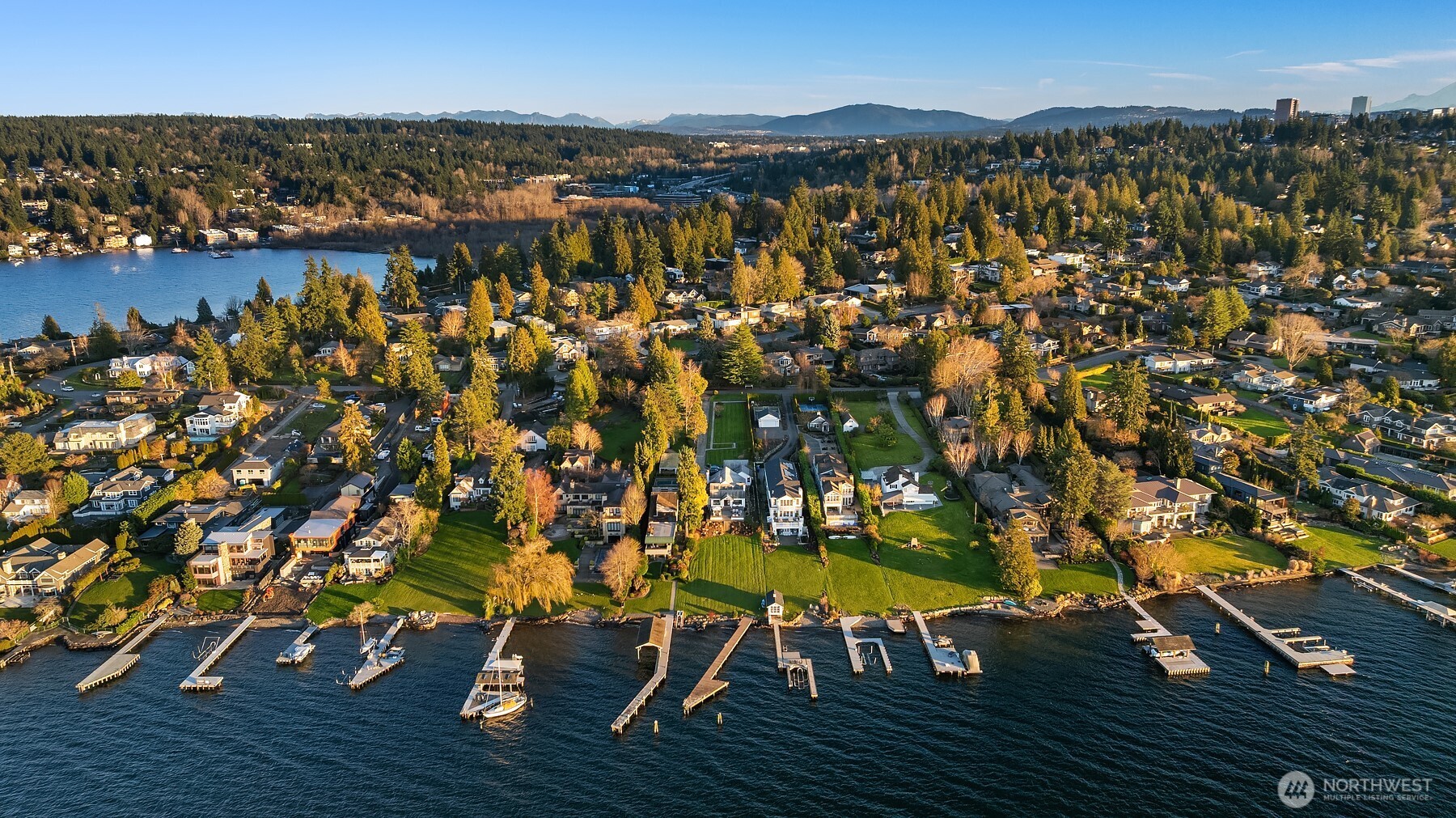 . Set on an expansive two-thirds of an acre lot with 62 feet of waterfront, this property offers front-row seats to golden sunsets over Lake Washington and the Olympic Mountains.