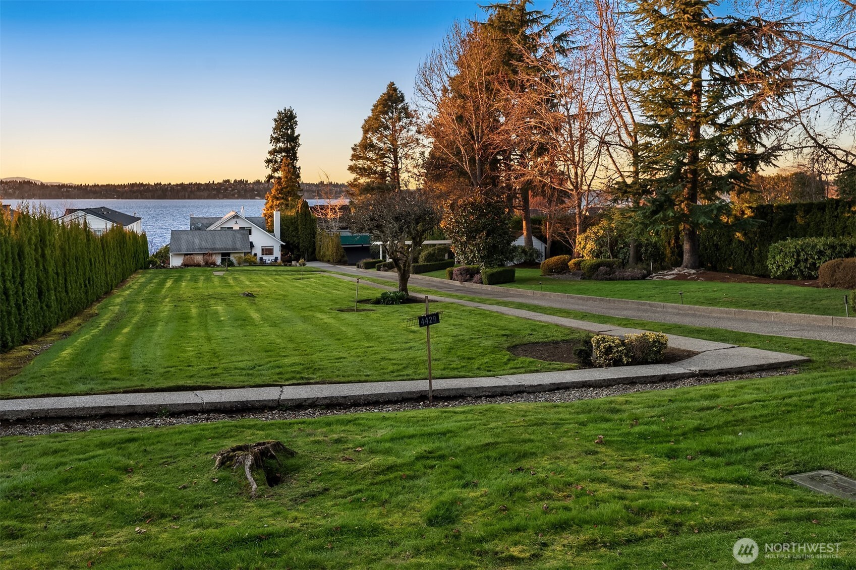 . A lush level lawn stretches to the shoreline, creating an idyllic setting for summer gatherings, lawn games, and easy access to your private dock for boating adventures.