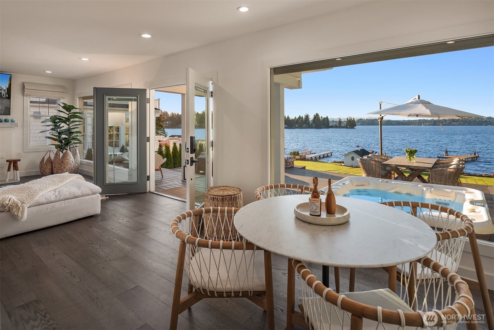 Seamless indoor-outdoor living with expansive lake views and direct access to the patio.