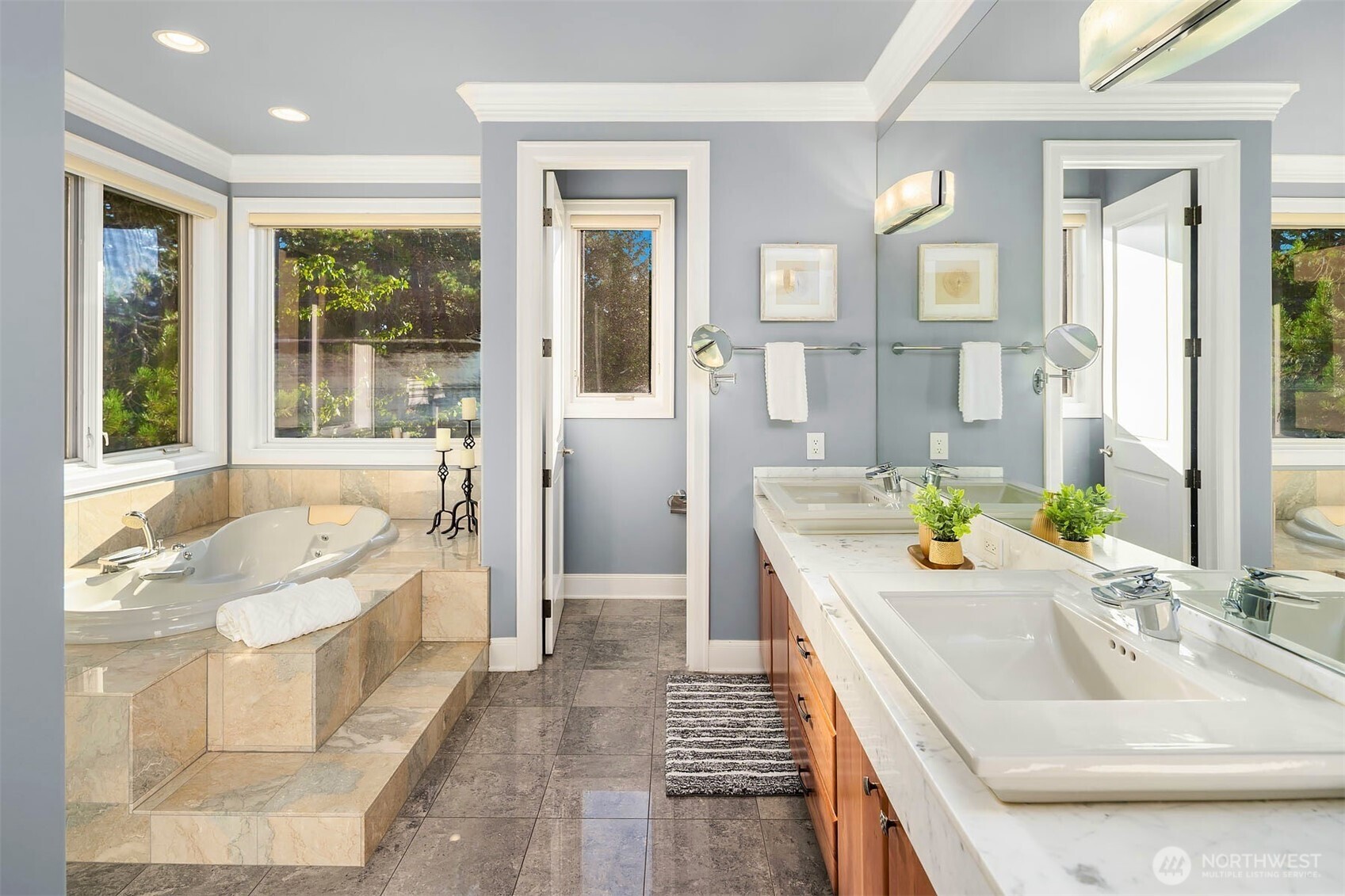 Large primary retreat with double fireplace with private deck access