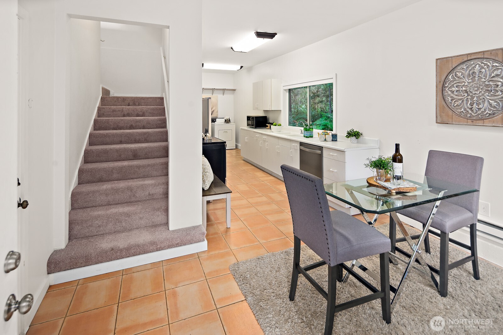 Welcoming entry with an eating nook and stairway to the upstairs bedroom.