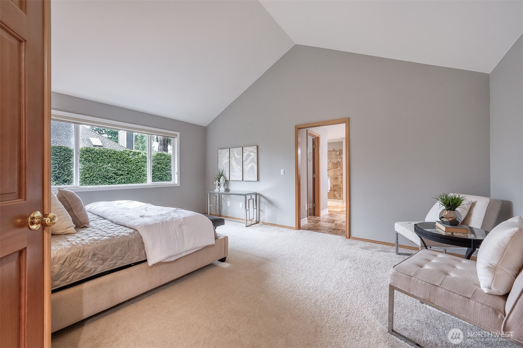 Vaulted ceilings make the primary suite bright and airy.