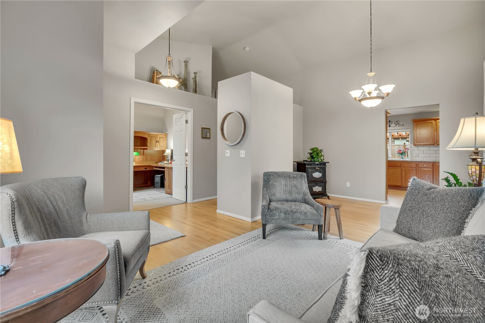 Main floor living room offers ample natural light and leads into the dining and kitchen areas.