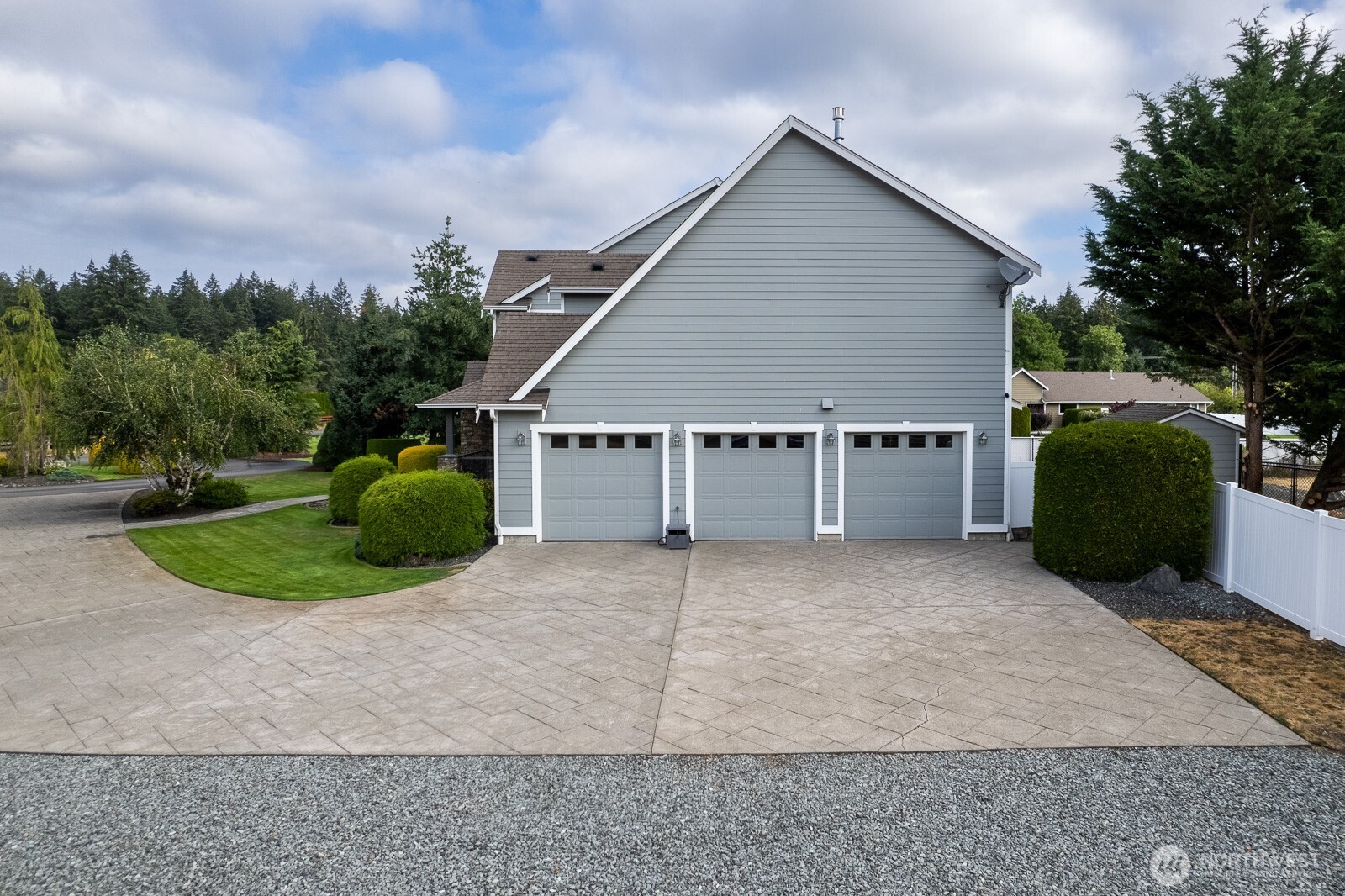3 car garage with a ton of parking space on driveway and extra gravel parking area