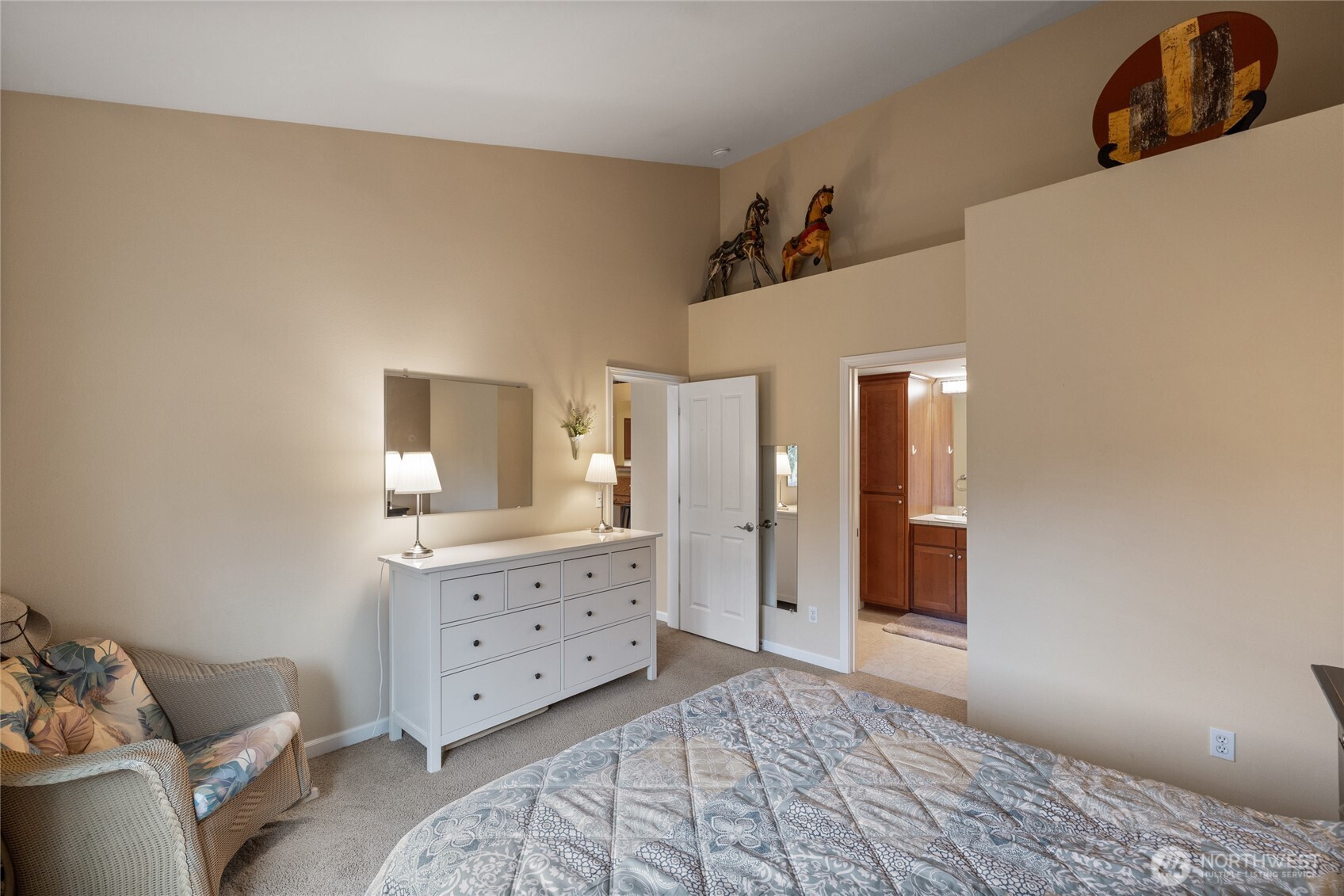 Main floor primary suite with view of greenspace.