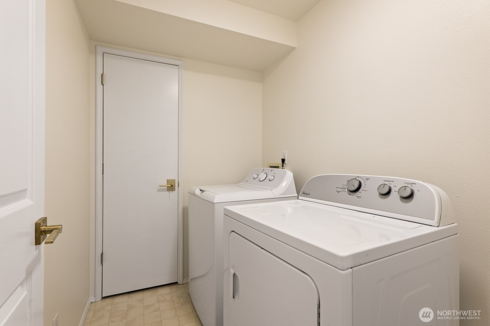Laundry room with full size washer and dryer and utility closet.