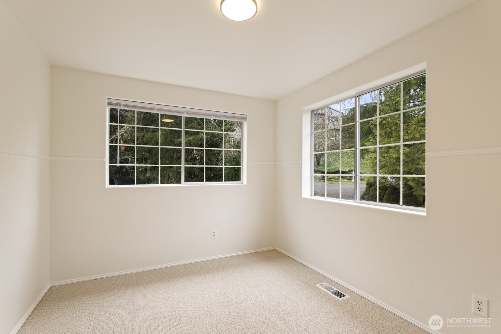 2 bedrooms overlook the front yard, this one with 2 windows.