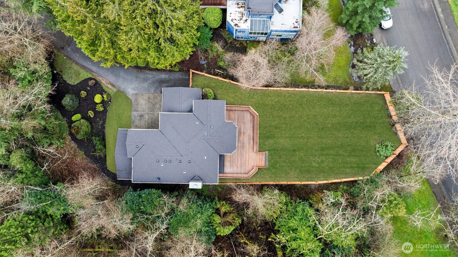 New fencing around the backyard and large deck with bench seating.