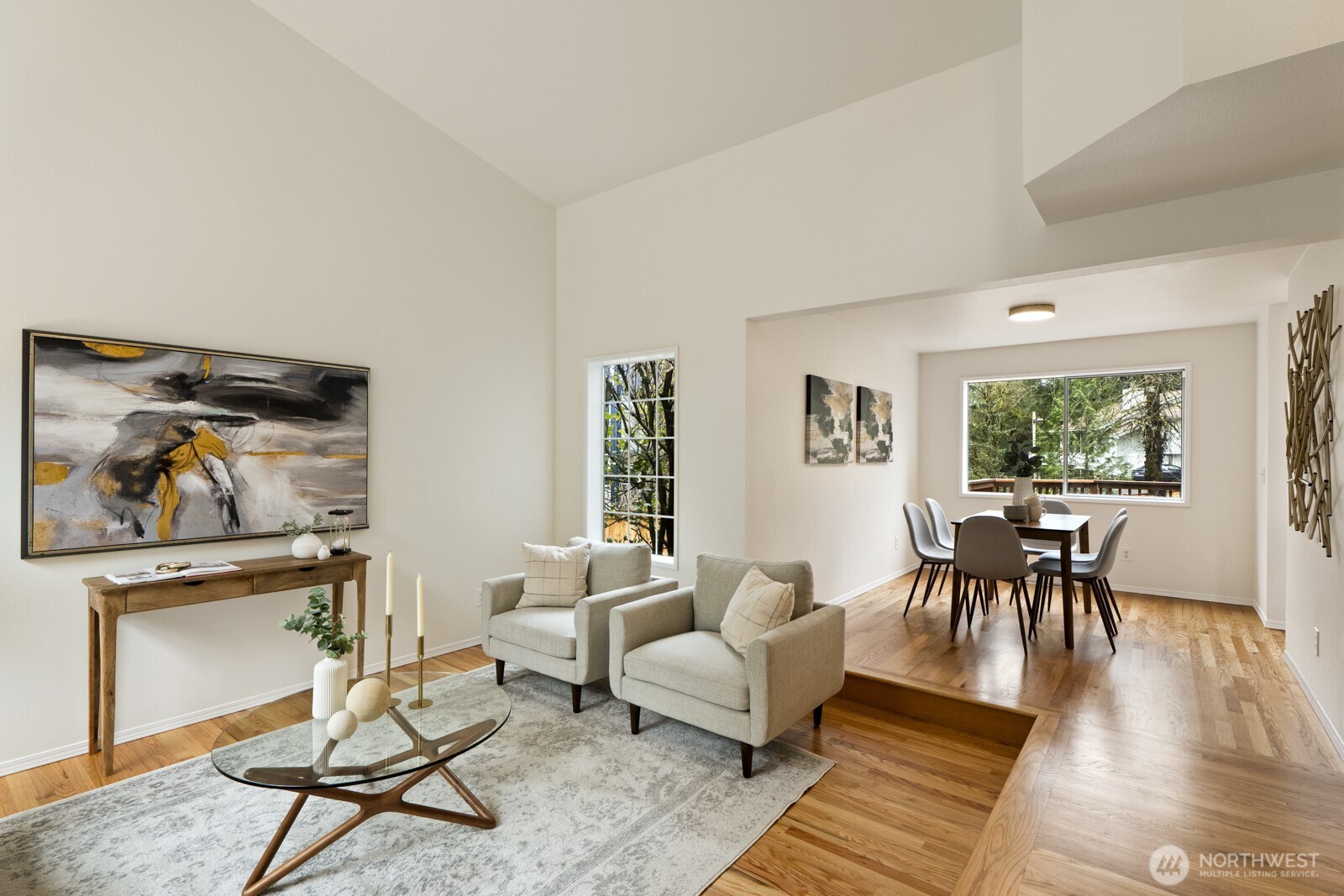 Living room with tall vaulted ceiling.