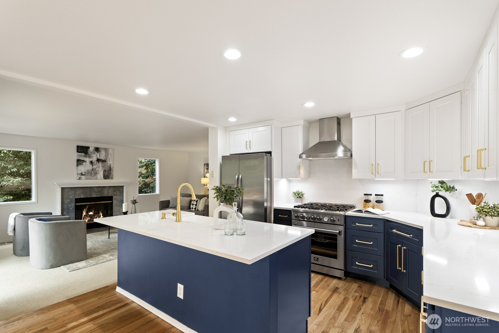 A modern show stopper, the kitchen boasts quartz counters, new navy cabinetry with brushed gold hardware.