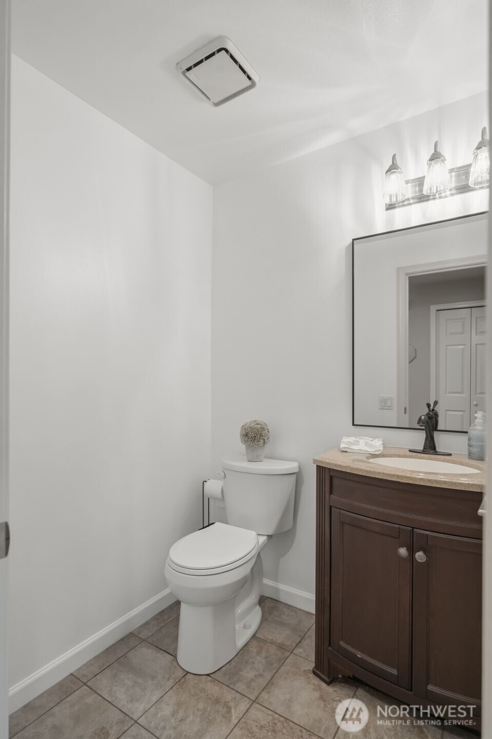 Just off the entry, a convenient powder room adds functionality for guests and everyday living.
