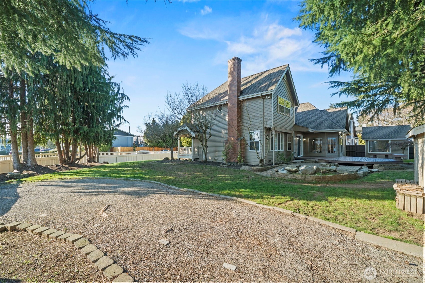 Aerial view showing the home’s setting on a spacious lot with mature trees and established neighborhood surroundings.