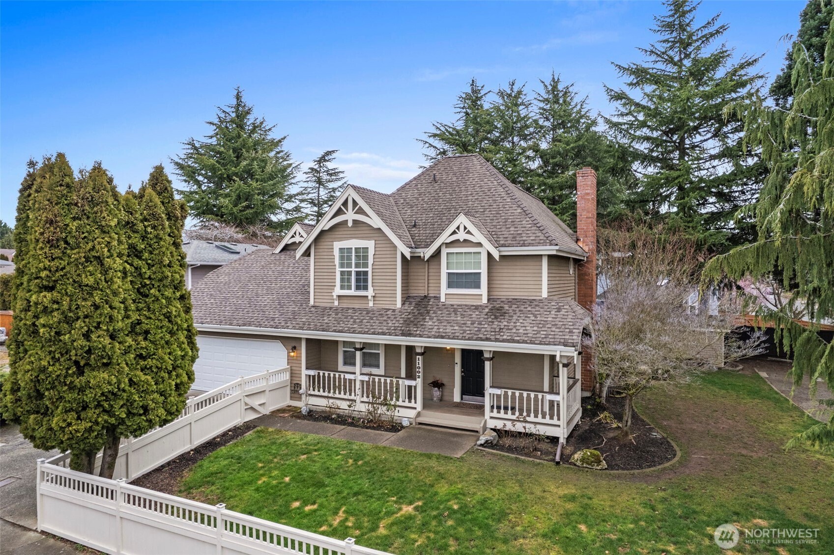 The warm gas fireplace creates a cozy focal point in the living room, surrounded by beautiful hardwood floors and natural light.