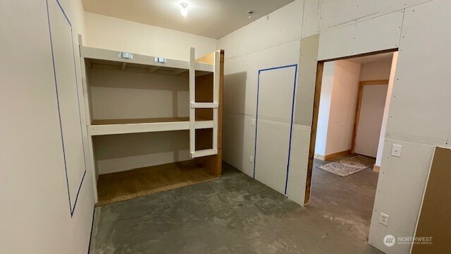 Blue tape shows approximate location of the framed door and windows in this roughed in space.