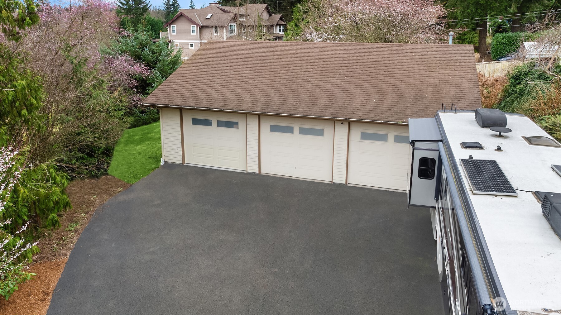 Detached, 2400 SF, 6-Car garage with additional room for RV parking. The garage has 3 over-height garage bays, each 2 car lengths deep.