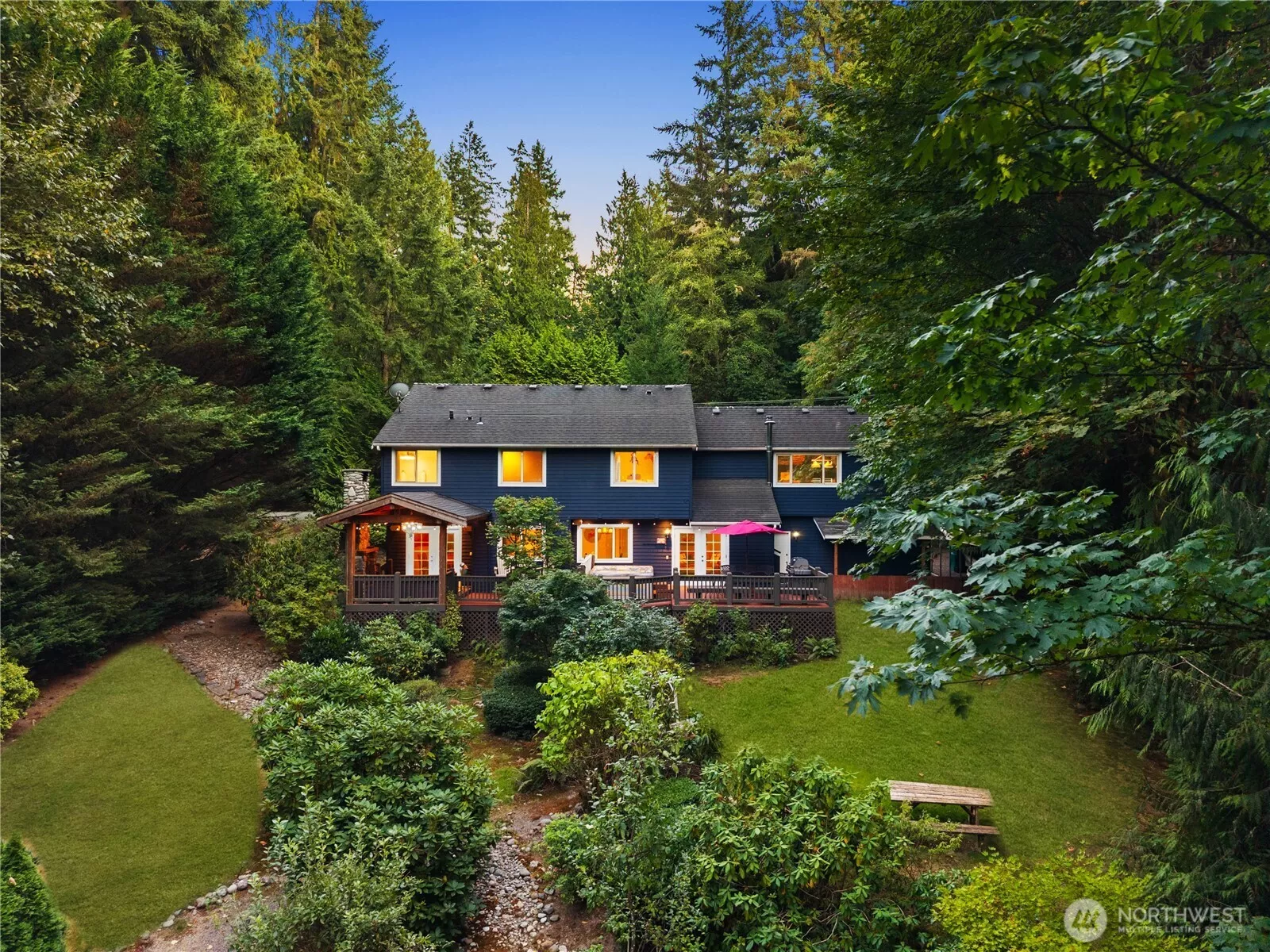 Stately front exterior with a wide driveway and a side-loading three-car garage for ample parking.