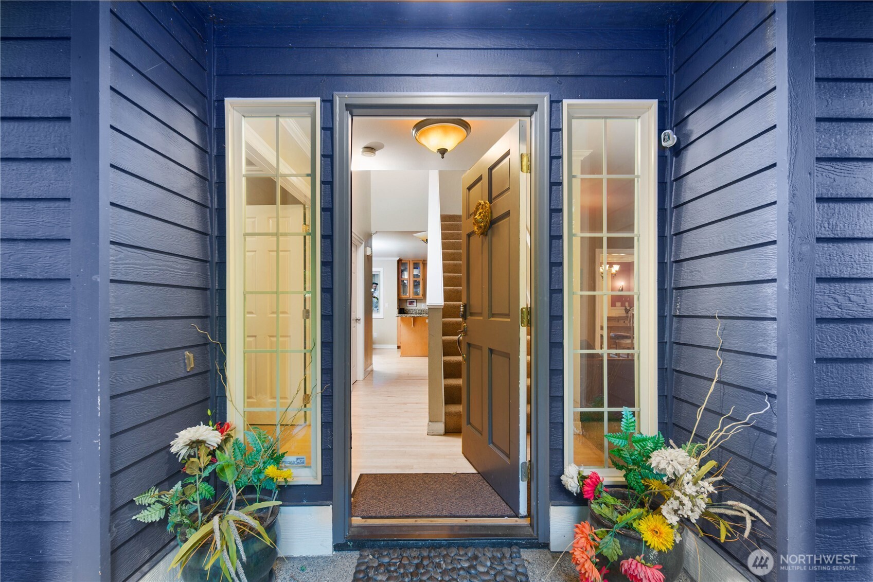 Chef’s kitchen featuring premium stainless steel appliances, granite countertops, and warm natural wood cabinetry.