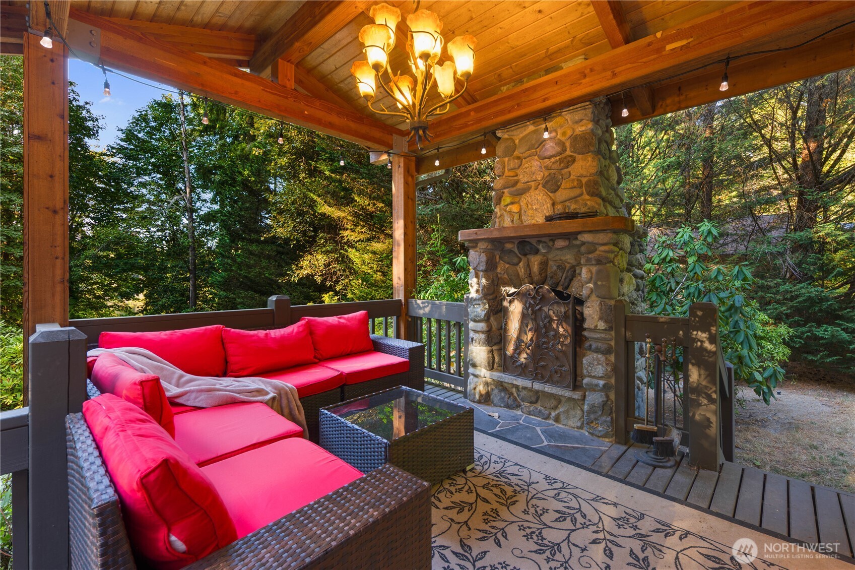 Stunning aerial view showcasing the home’s incredible privacy within a lush, lakeside wooded community.