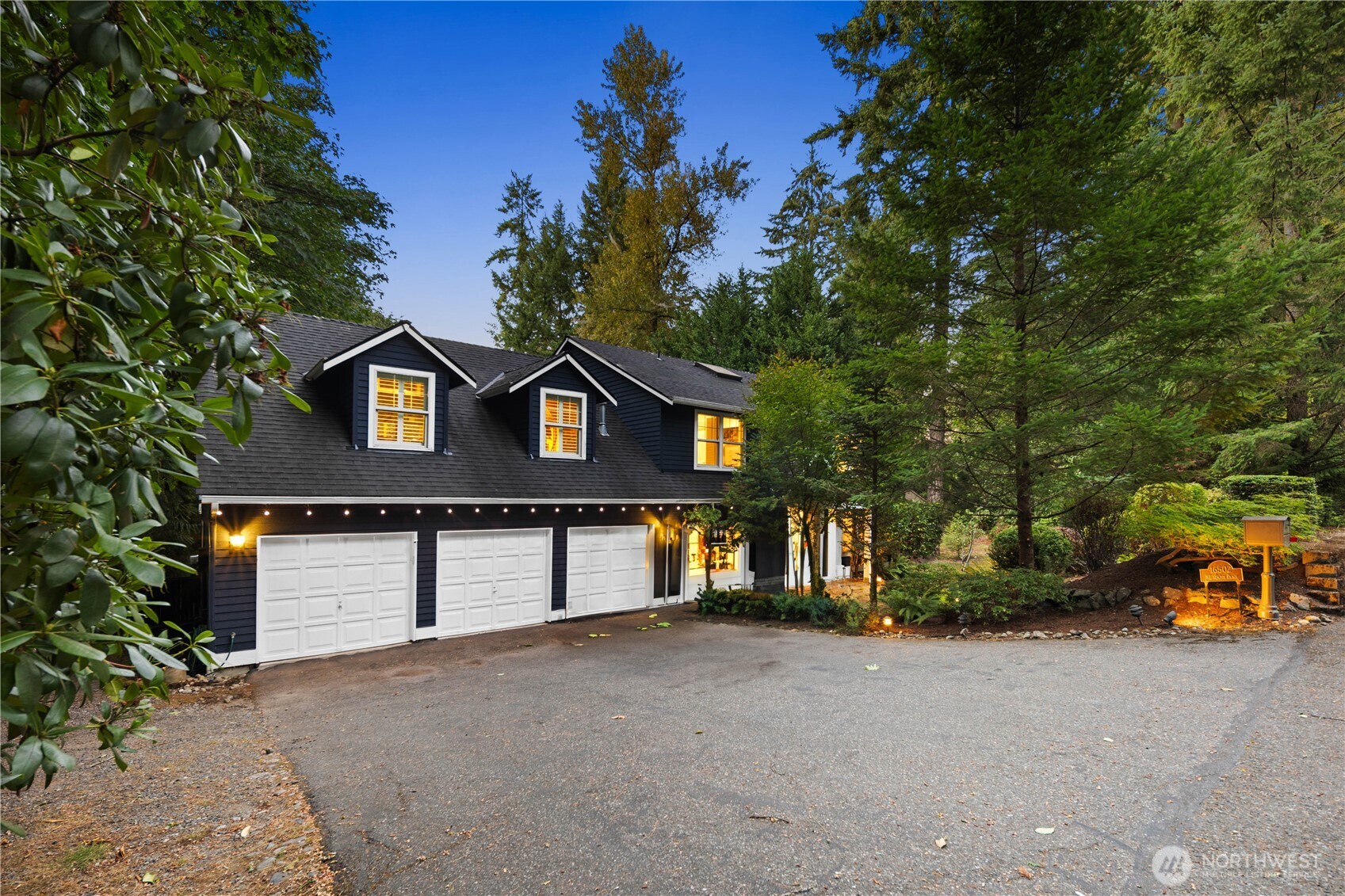 Artfully landscaped grounds featuring stone pathways that lead through lush, mature greenery.