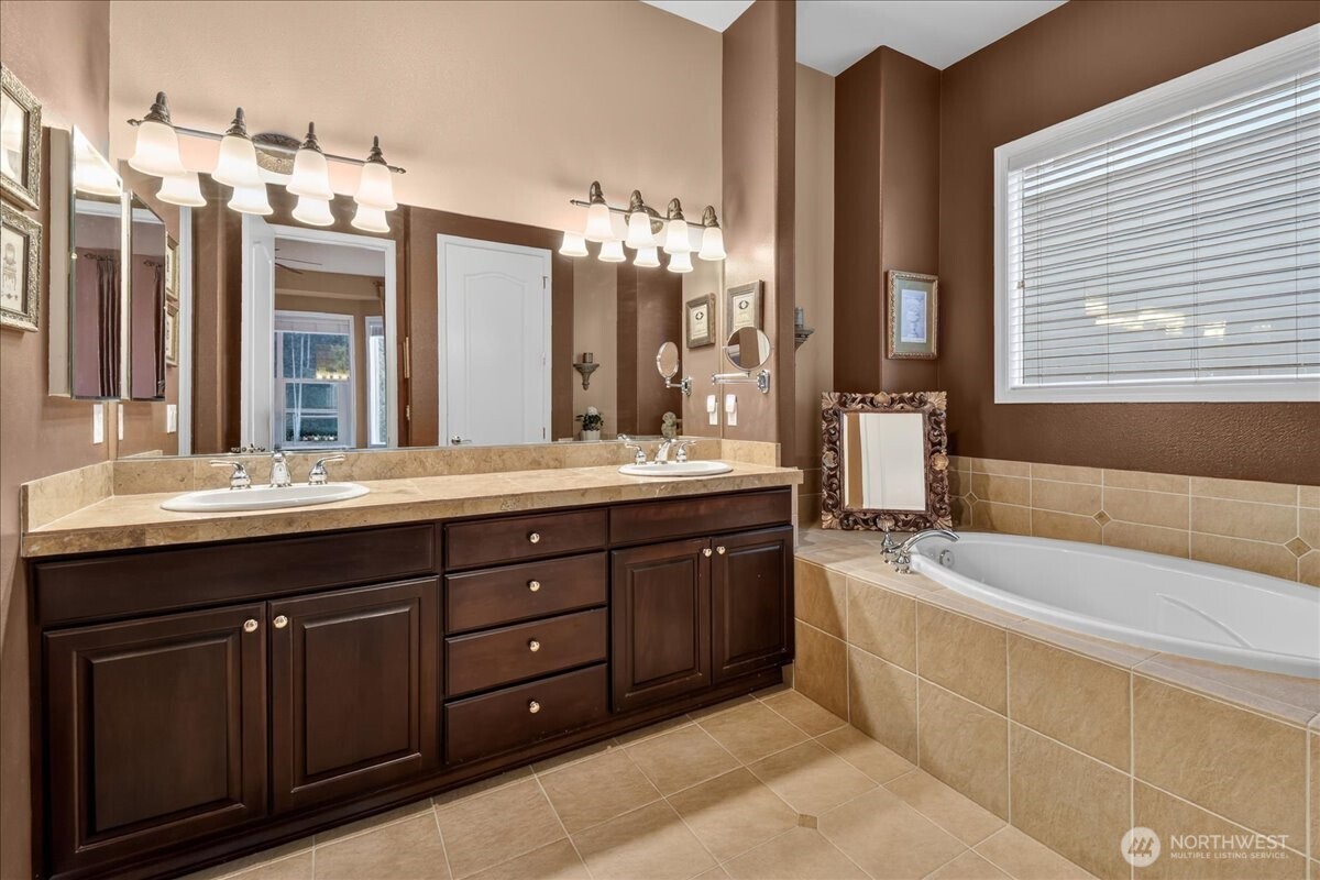 Guest Bath Room with Medicine Cabinet, opulent shower rod and curtain, and tile counter and flooring.
