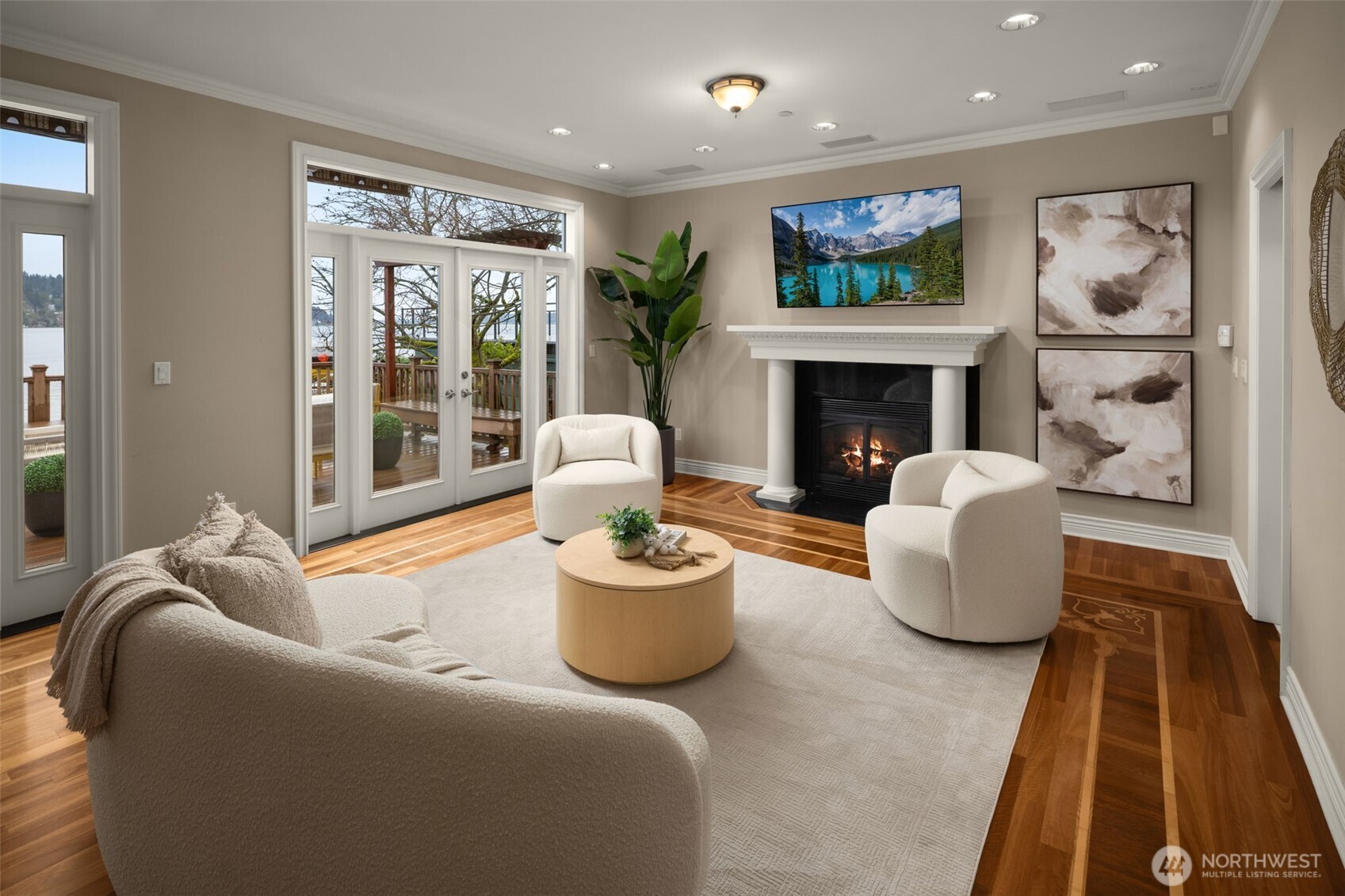 Intimate living space centered on a fireplace with access to the waterfront deck.