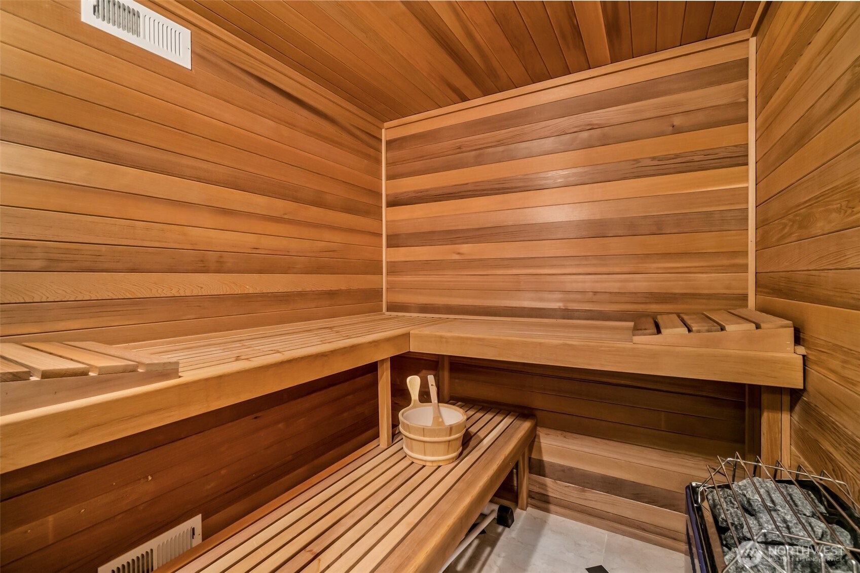 Beautifully crafted cedar sauna provides a tranquil wellness space, bringing resort-style relaxation right into the home.