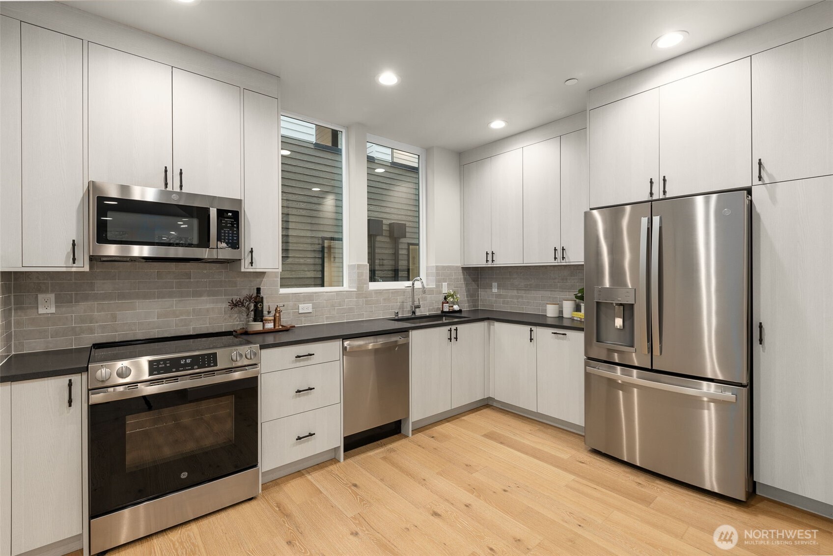 Sleek gourmet kitchen featuring professional-grade stainless steel appliances and ample cabinetry
