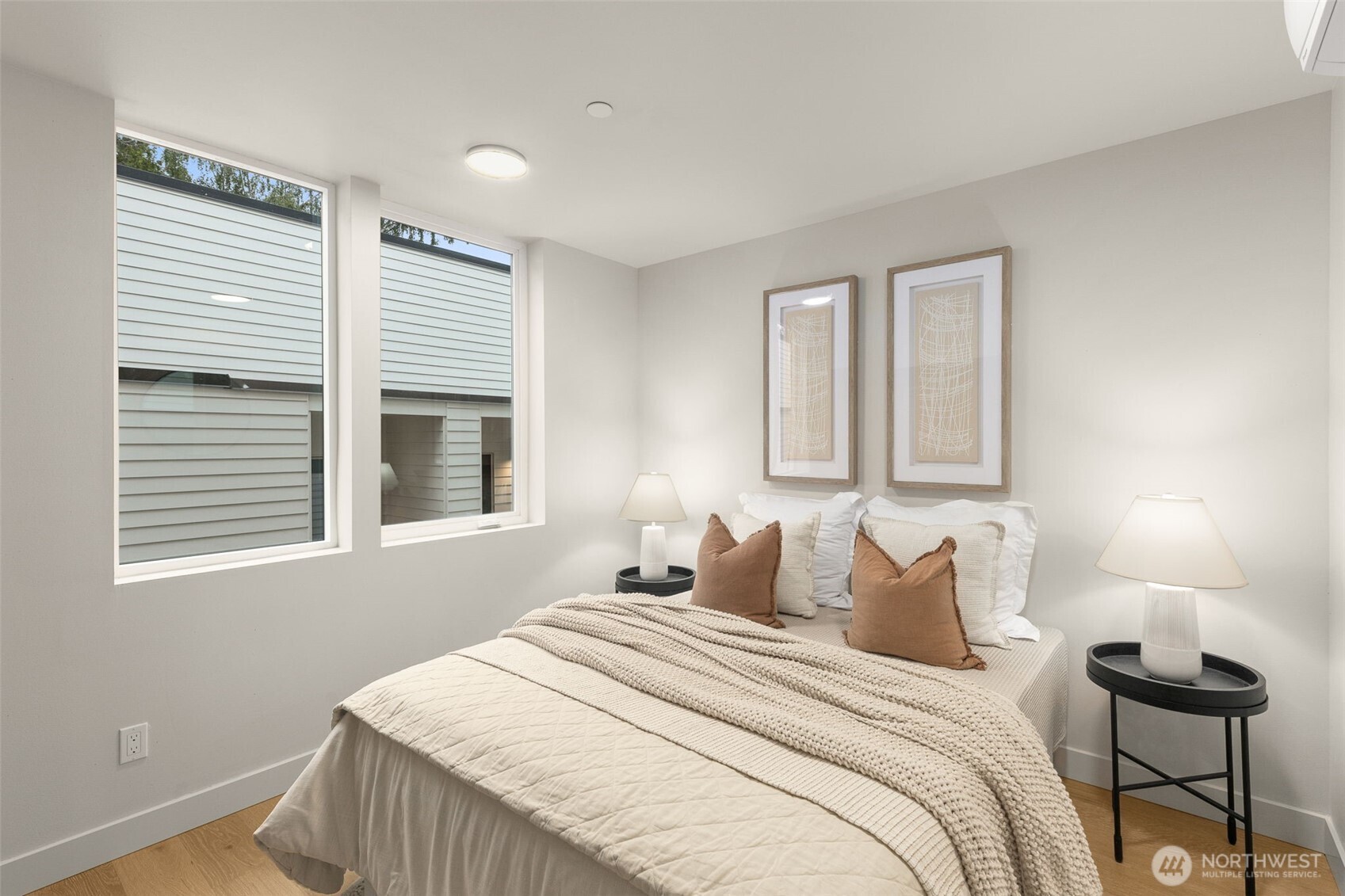 Serene primary suite offering generous proportions, large windows, and a calming atmosphere