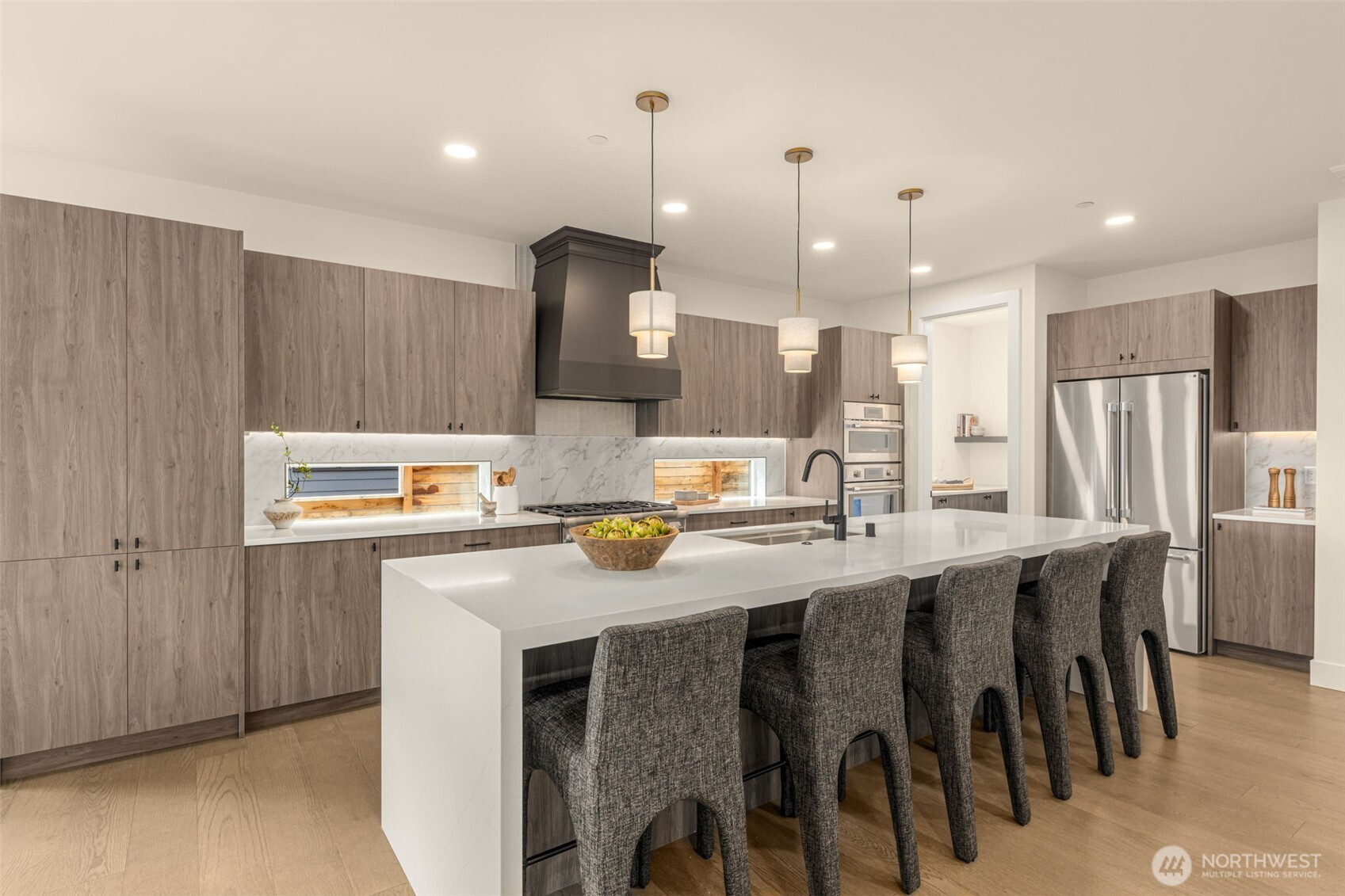 Kitchen walk-in pantry with built-in shelving.
