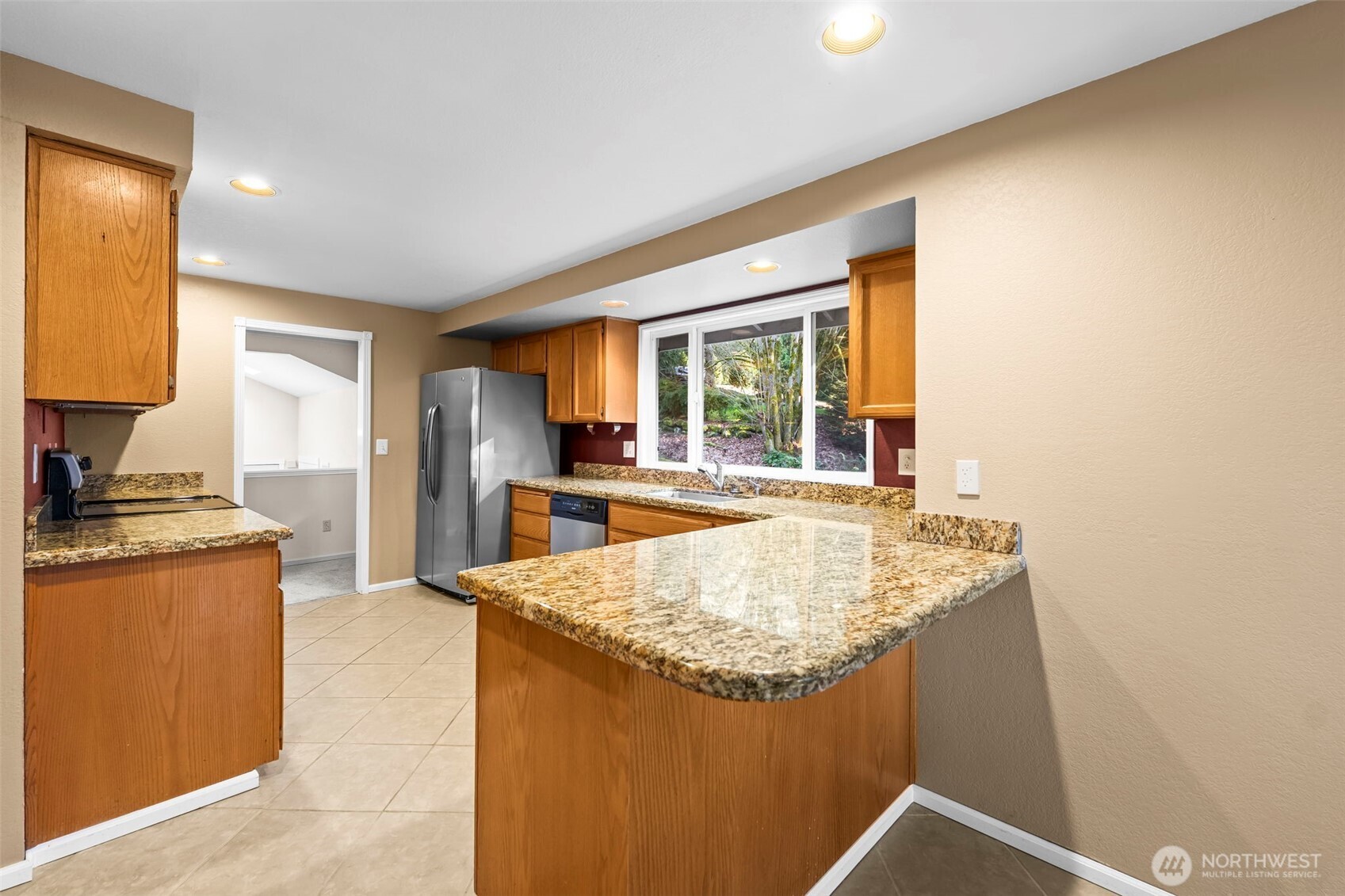 Spacious entertaining space with sliding doors leading to back deck.