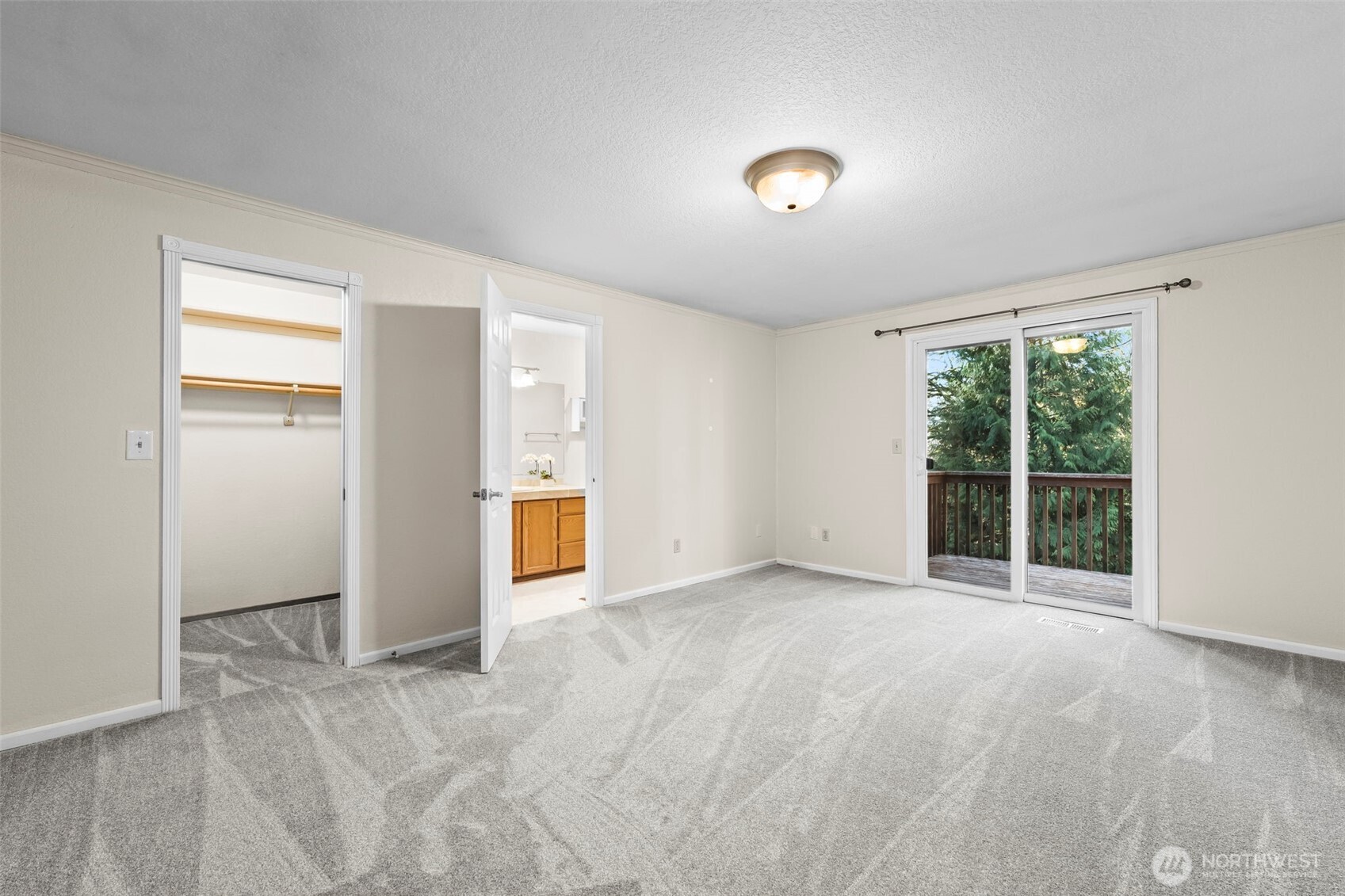 Primary bedroom has a private bath and direct deck access.